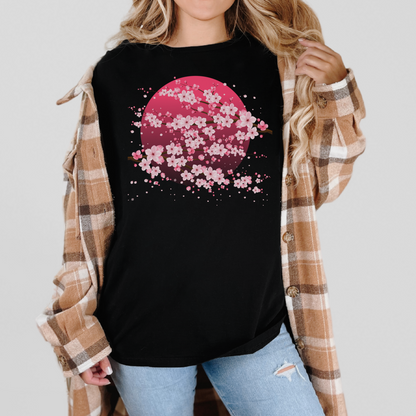 Image: A pink cherry blossom t-shirt featuring a delicate sakura tree design. The soft, durable fabric offers comfort, while the classic fit makes it versatile for any occasion. Perfect for springtime celebrations, Japanese aesthetic lovers, and those who appreciate kawaii fashion. Ideal as a gift for teens and adults. 