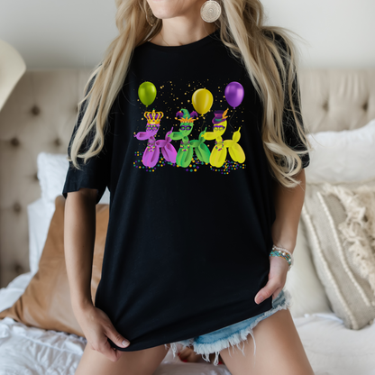 Image: Mardi Gras Balloon Dog Adult Shirt. This New Orleans Carnival tee features three balloons dogs, wearing Mardi Gras masks and hats. They have beads and balloons with confetti, by jaecrece