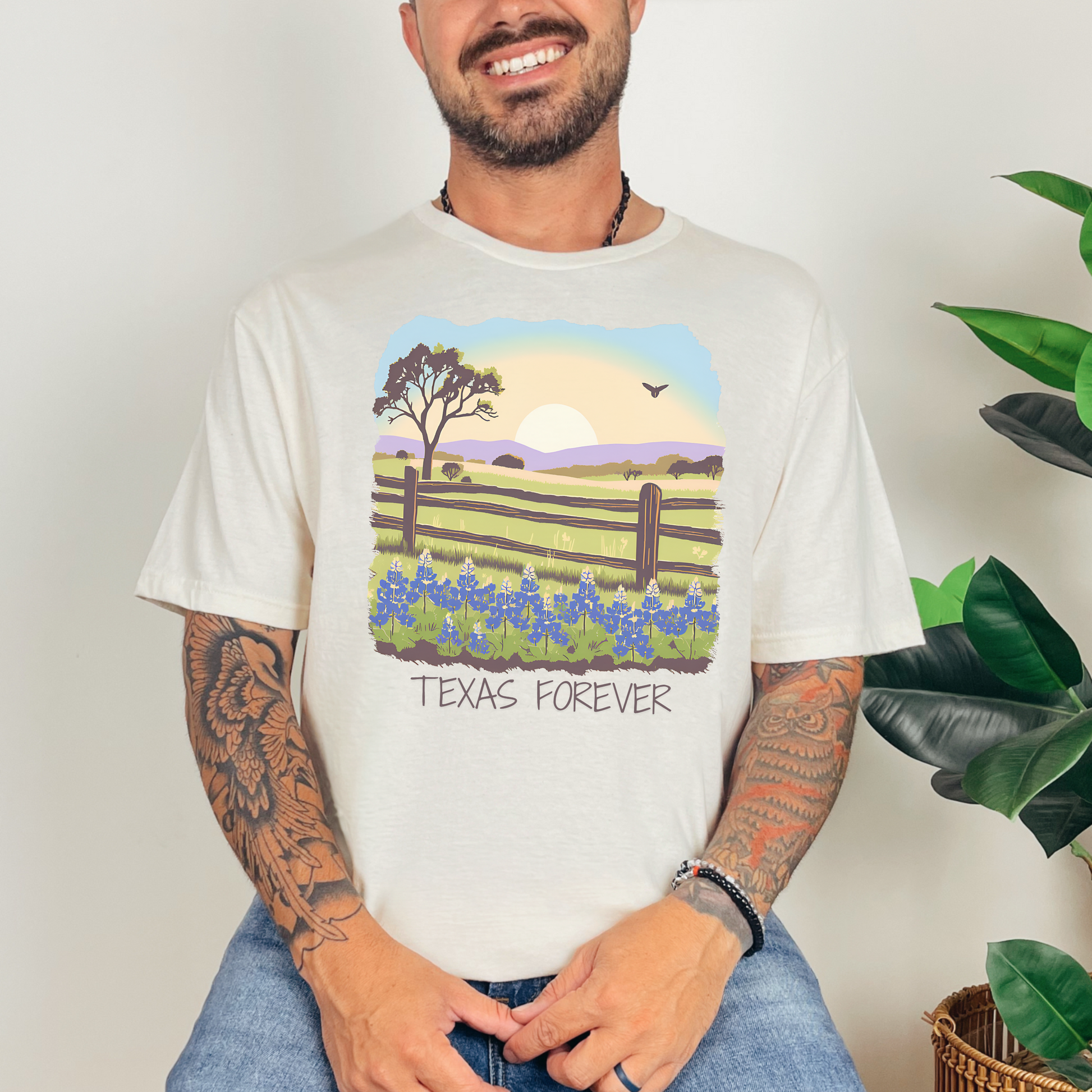 Image: A vibrant Texas wildflower T-shirt featuring a picturesque landscape of bluebonnets under a glowing Texas sky. The "Texas Forever" text adds a meaningful touch for those who hold the Lone Star State close to their hearts. A great choice for western wear, road trips through Hill Country, or country music festivals. Comfortable and stylish, this Texas-themed tee makes an excellent gift for cowgirls, cowboys, or proud Texans, by jaecrece.