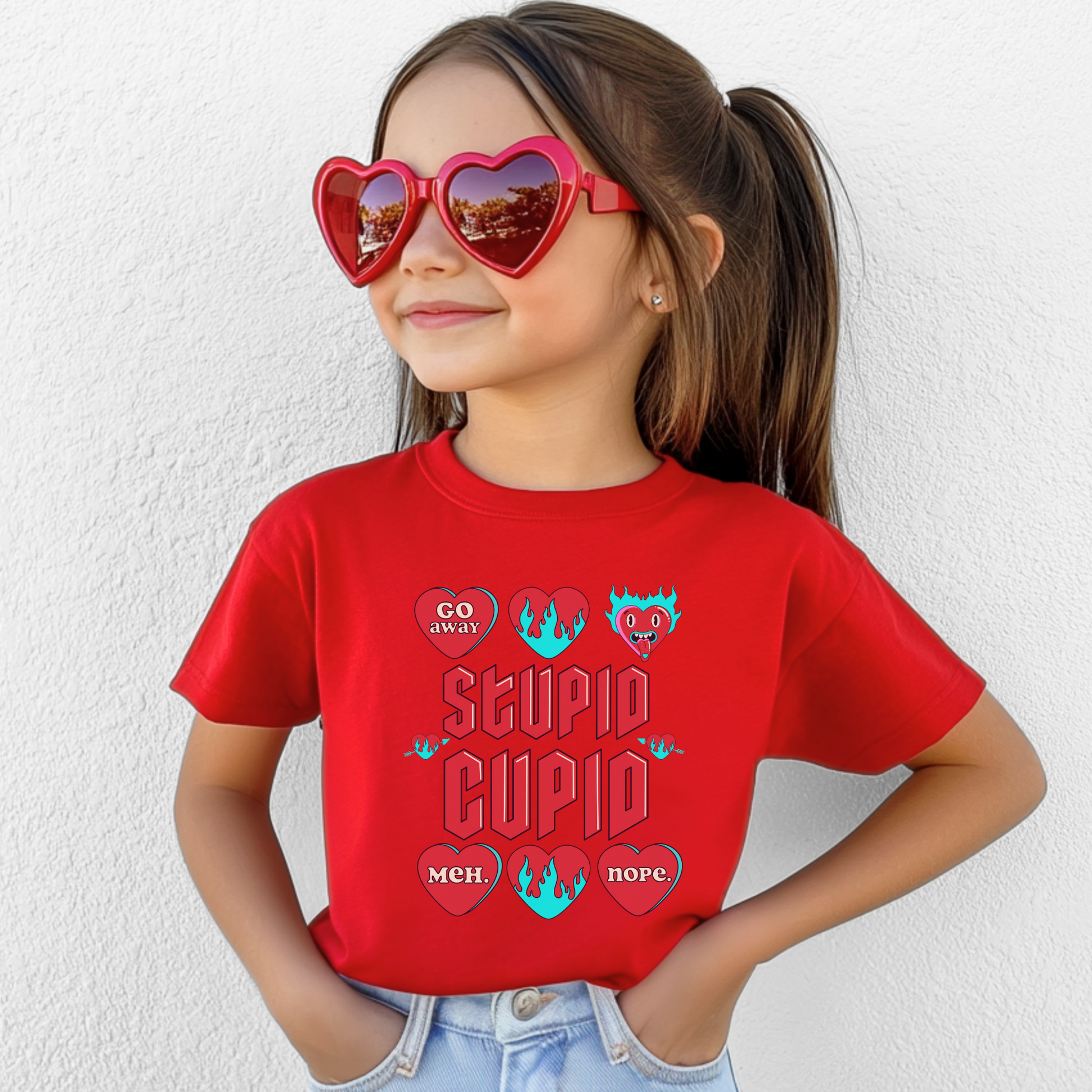 Image: Stupid Cupid Anti Valentines Day T-shirt for Kids. This sweatshirt is for girls and boys with red 90s style text that reads Stupid Cupid, with conversation hearts that are on fire, or say Go Away, Meh, Nope. Great for school party, by jaecrece