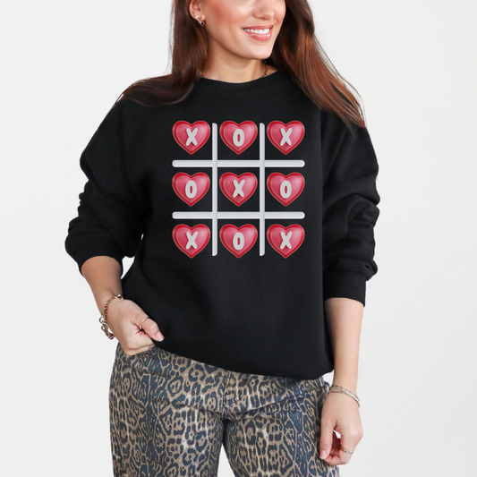 Image: XOXO Sweatshirt in Hot Pink, this crewneck pullover features a tic tac toe graphic with XOXO in 3D Conversation Hearts. Ideal as a teen gift for her or Galentines day. Available in Hot pink, light pink and black, by jaecrece