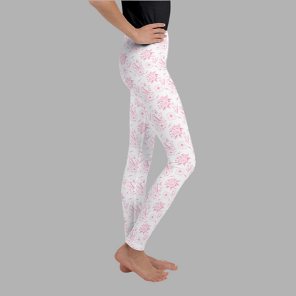 Image: Girls pink toile leggings in youth sizes 8 to 20, designed with a romantic floral pattern that captures classic elegance. These comfy, stretch leggings are ideal for tweens who love soft colors and vintage vibes. Whether worn to school, layered under dresses, or styled for spring photos, this toile print adds timeless charm to any outfit. Part of a matching family look collection, by jaecrece.