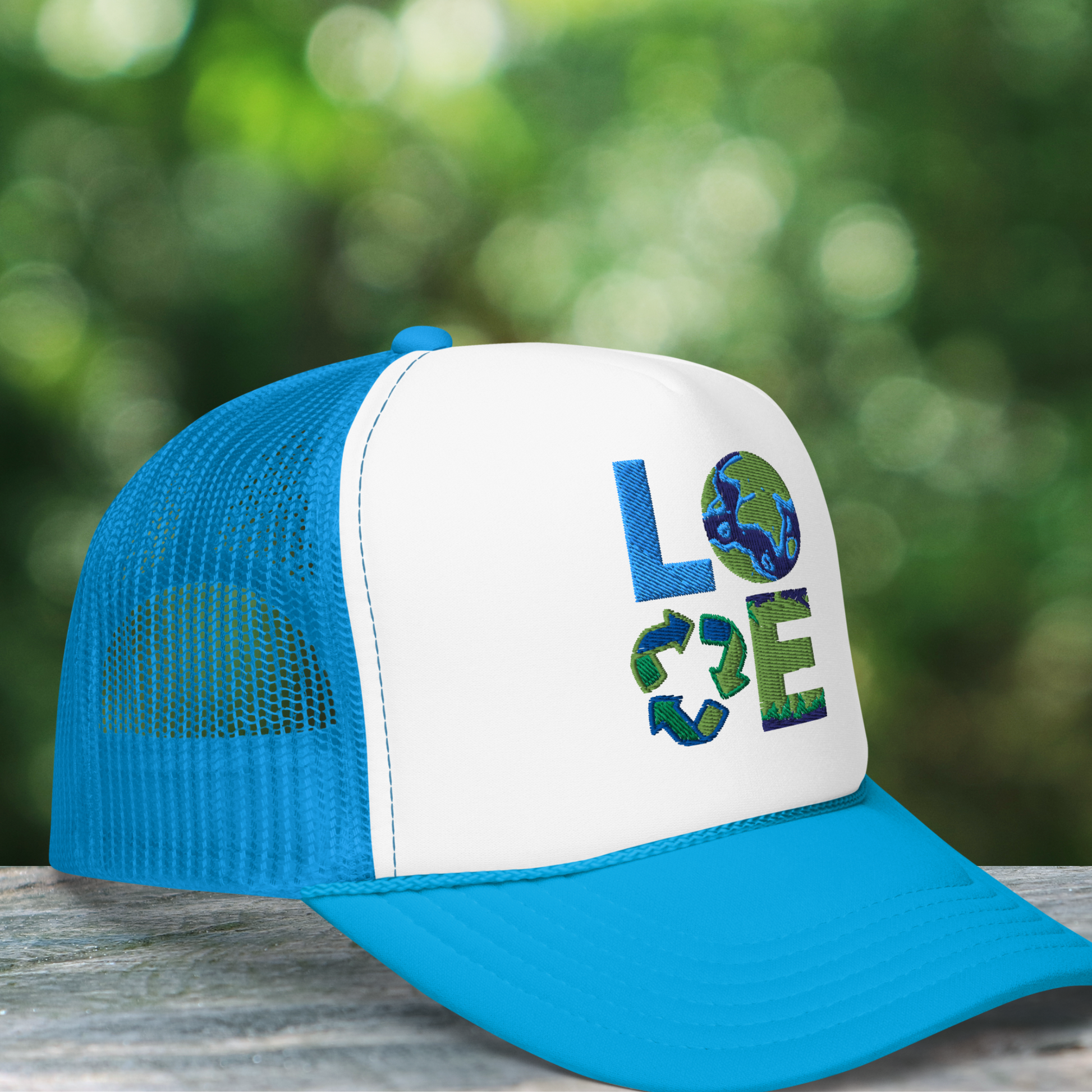 Image: Earth Day Foam Trucker Hat. This Save the Planet Unisex Hat has a teal blue bill and mesh back. The front of the baseball cap has LOVE embroidery to represent our planets oceans, plants and a commitment to reduce reuse and recycle, by jaecrece