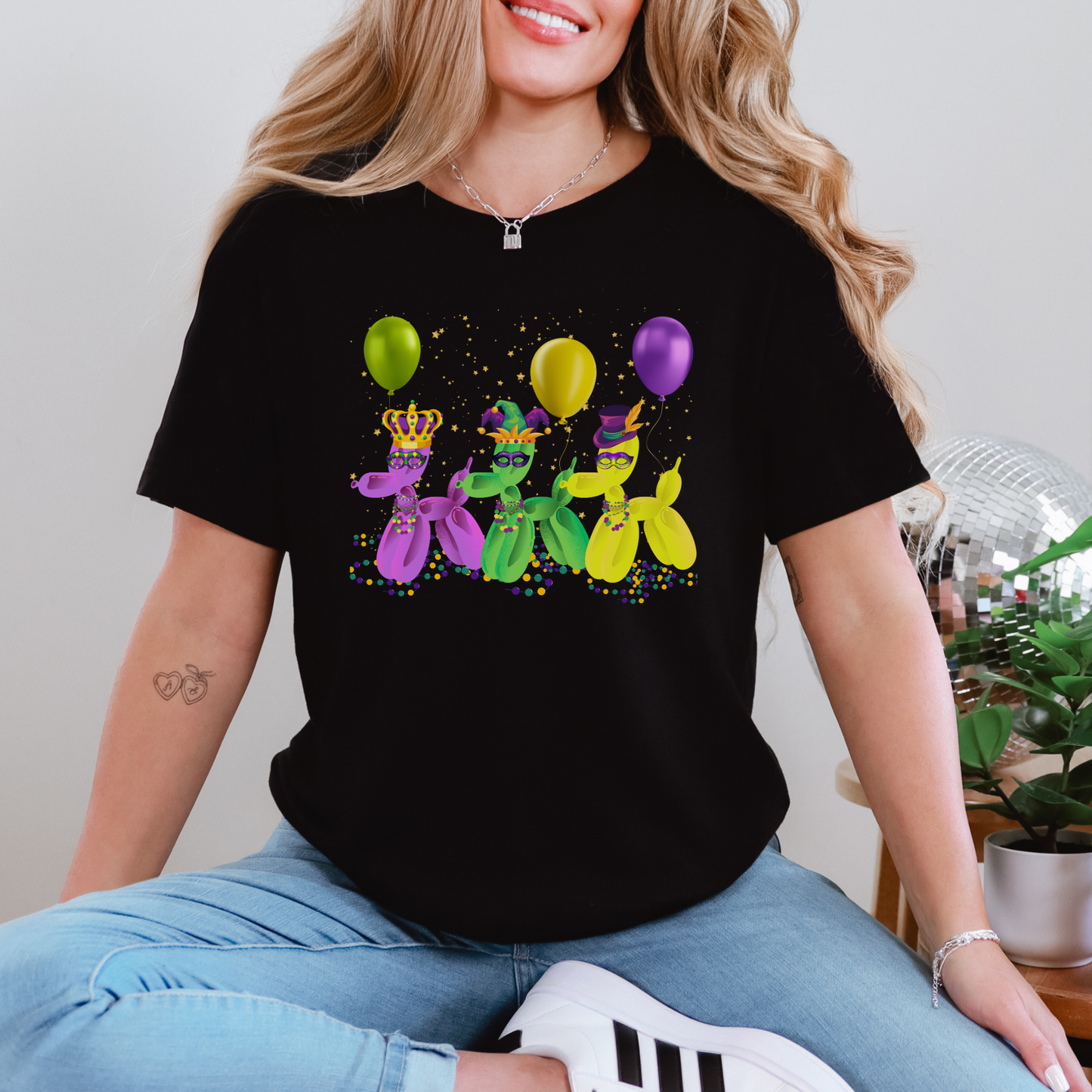 Image: Mardi Gras Balloon Dog Adult Shirt. This New Orleans Carnival tee features three balloons dogs, wearing Mardi Gras masks and hats. They have beads and balloons with confetti, by jaecrece