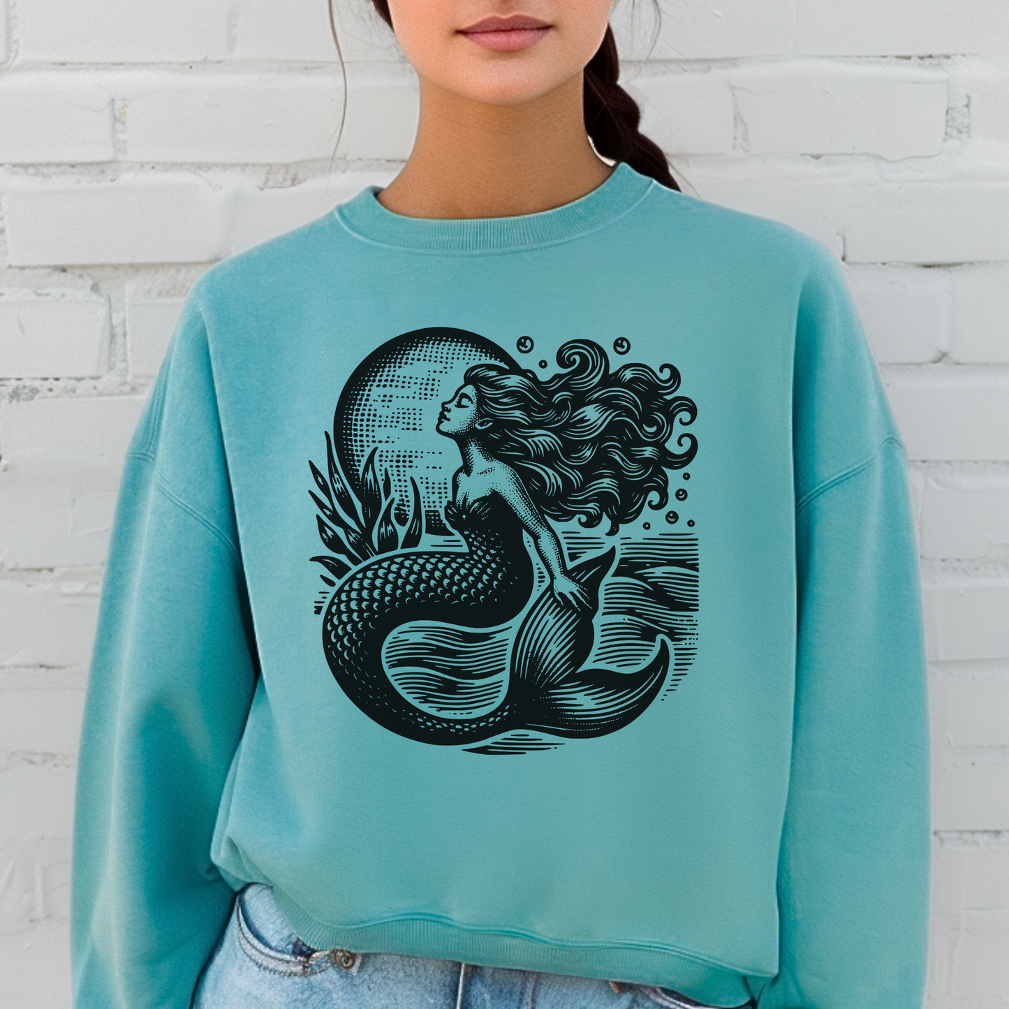 Image: Mermaid  Sweatshirt, Vintage Ocean Vibes Sweatshirt. Pullover crewneck features large black graphic with mermaid in front of the moon, in the ocean waves. Gift for women and teens who love a vintage ocean aesthetic and mermaidcore, by jaecrece