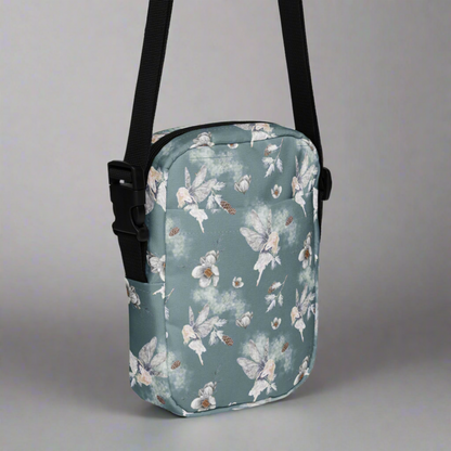 Grey small canvas crossbody utility bag, with a repeating fairy, floral and pinecone pattern. This hiking biking small tote can be worn on the hips, waist or cross the chest. The perfect gift or festival pouch for ladies, teens and tween. By jaecrece