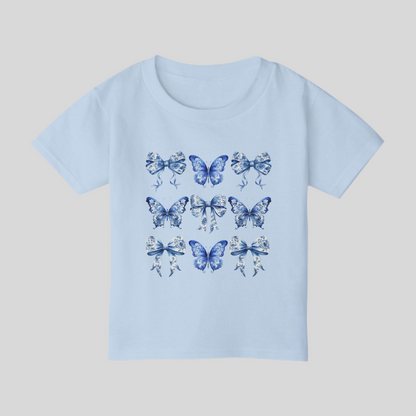 Blue Toile toddler tee for girls features a classic butterfly and bow motif in soft blue hues, perfect for fans of cottagecore, Texas coquette trends, and coastal cowgirl style. Designed for comfort and charm, this cute spring shirt for toddlers is ideal for everyday play or family matching moments. Sizes 2T to 6T make it easy to twin with older siblings or moms. An aesthetic, versatile gift for fashionable little ones, by jaecrece.