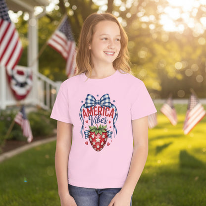 America 250 patriotic strawberry youth t shirt on Comfort Colors cotton featuring nostalgic summer inspired artwork with stars strawberry graphic and gingham bow accents. Soft breathable garment dyed tee with relaxed fit for girls. Perfect for 4th of July celebrations mommy and me matching outfits patriotic family photos summer barbecues and vintage Americana themed kids outfits
