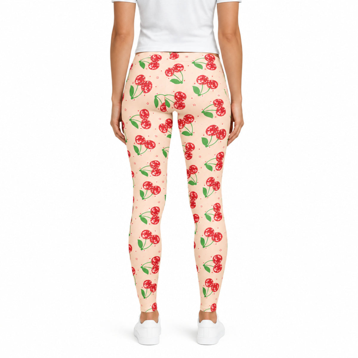 Back view of pink cherry print womens leggings showing the bright pink fabric, sparkling red cherry design, comfortable mid rise waistband and full length fit. This view clearly shows the back of the leggings and their colorful retro design while keeping the actual garment proportions and fit visible for shoppers.
