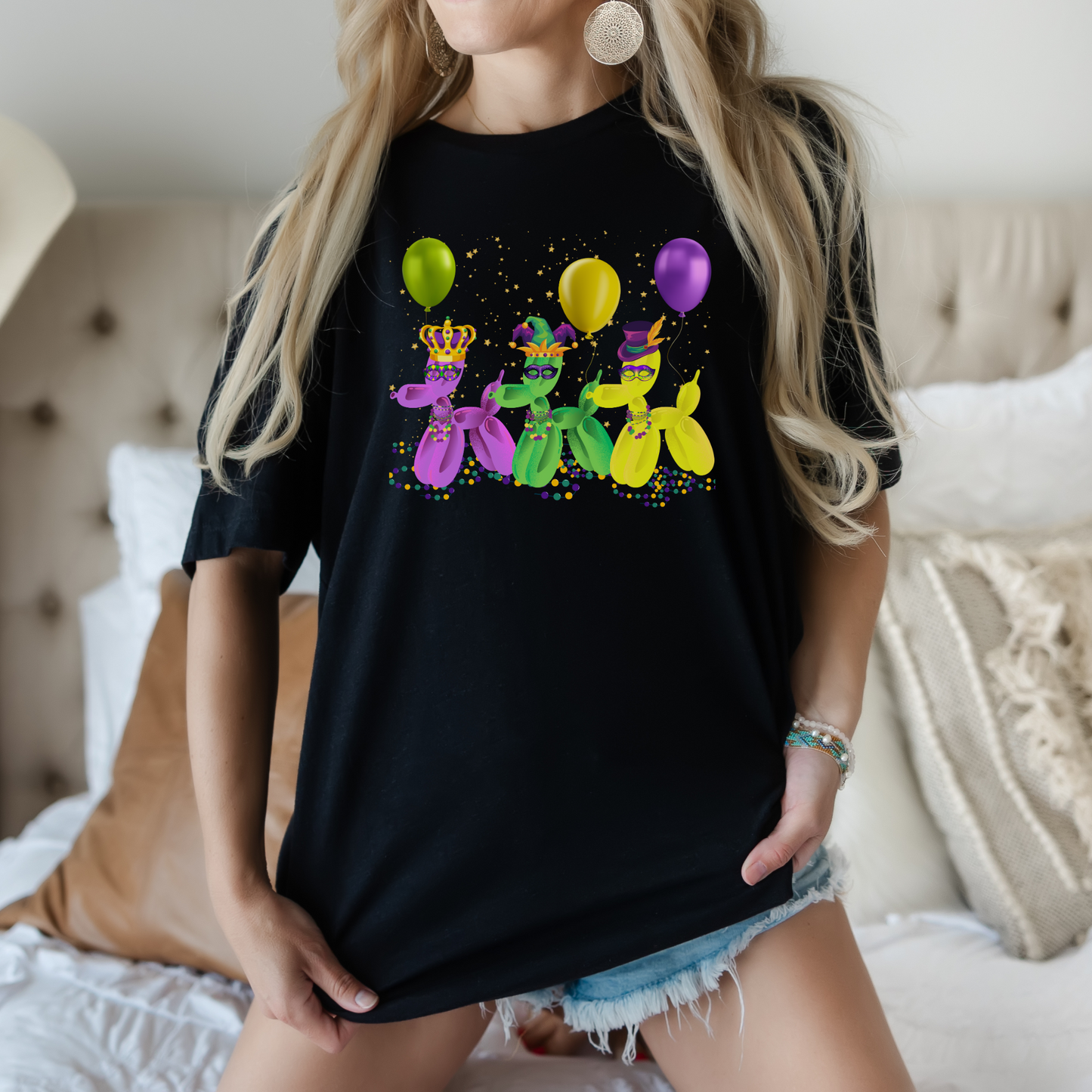 Embrace the fun of New Orleans Mardi Gras with this whimsical balloon dog t-shirt in black, featuring three colorful pups in purple, gold, and green. This playful French Quarter-inspired graphic tee makes a unique Fat Tuesday outfit or a fun souvenir from NOLA. Made for comfort and bold style in sizes XS–5XL, it's ready for Carnival season and beyond.