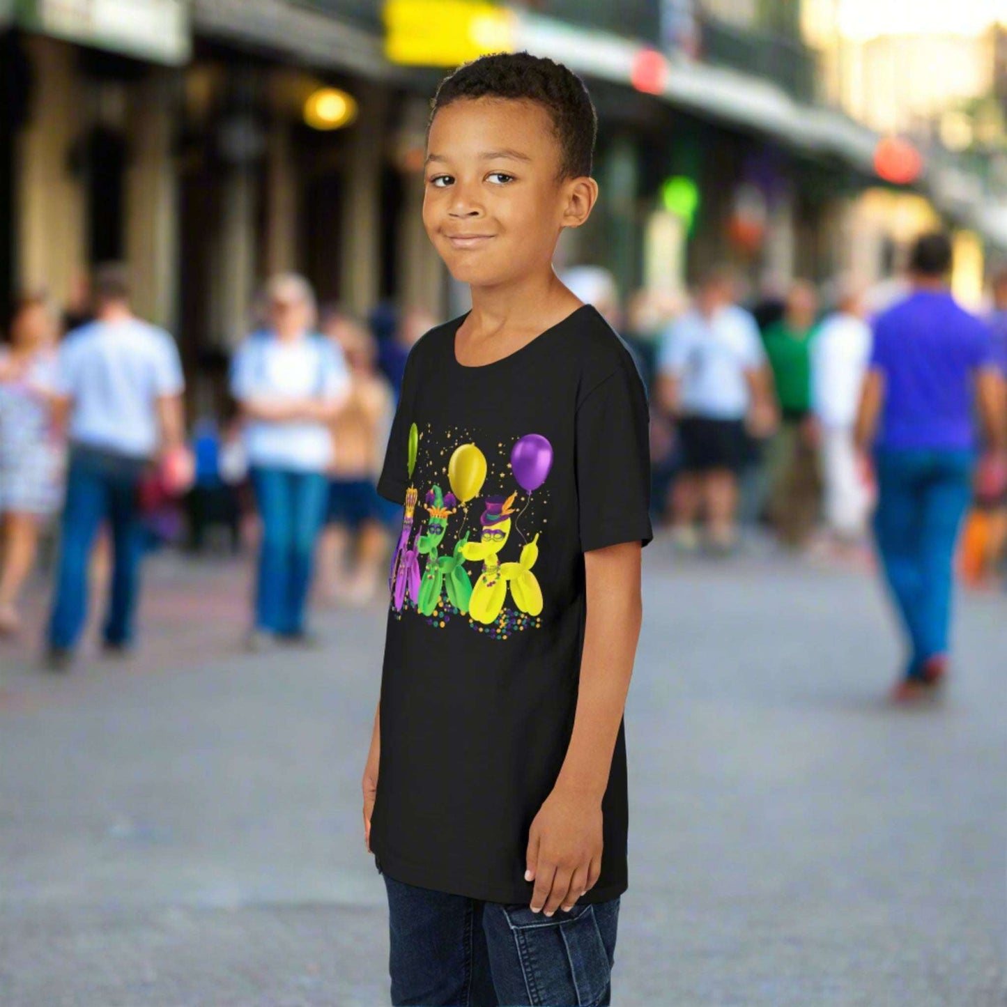 Let kids celebrate Mardi Gras in style with this youth-sized black t-shirt featuring festive balloon dogs in gold, purple, and green. The playful “walk it like a dog” theme captures the fun of New Orleans parades and French Quarter street celebrations. With beads, confetti, and Carnival hats, it’s made for matching the whole family and showing off that Mardi Gras pride all season long.