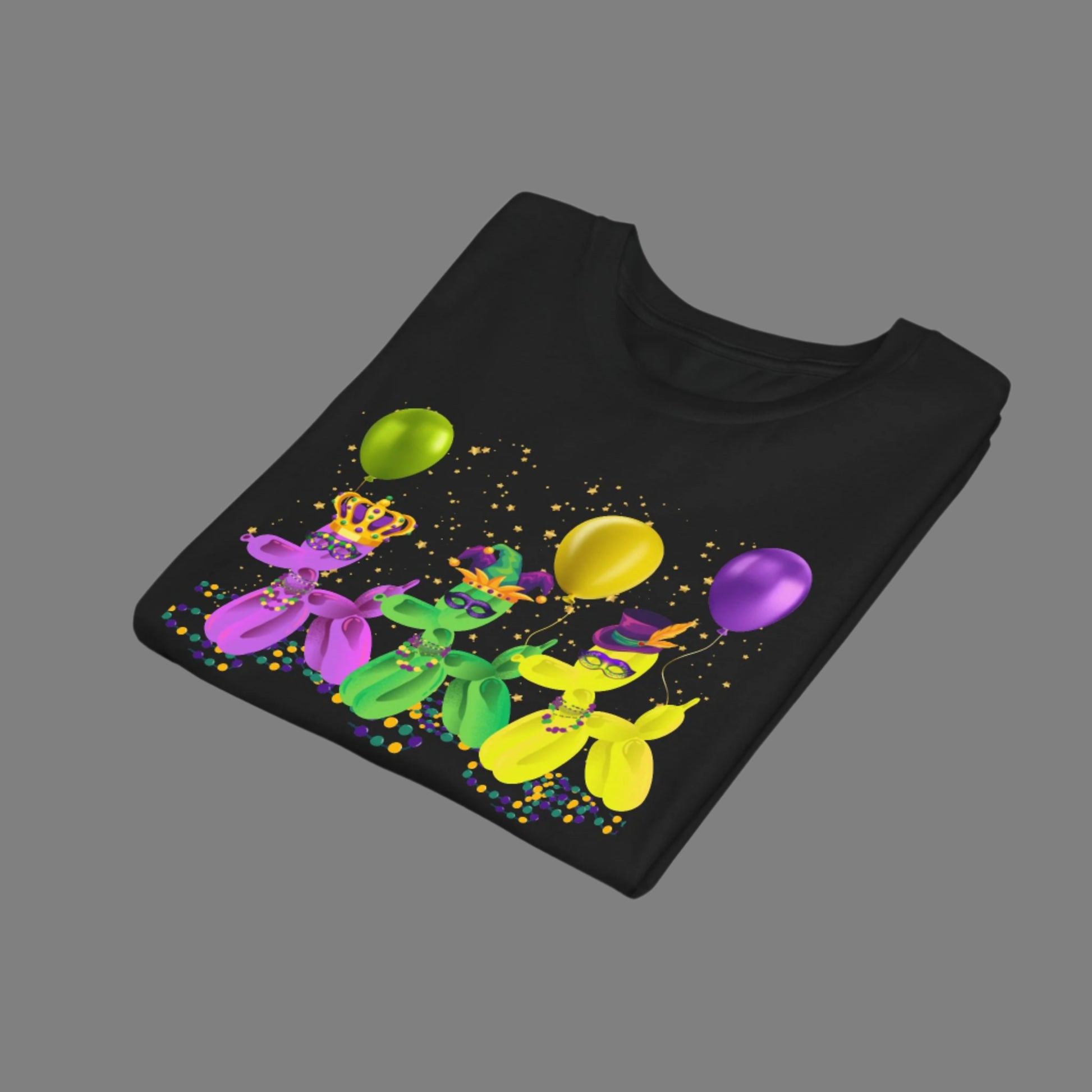 Image: Mardi Gras Balloon Dog Child Tshirt, folded. This youth Mardi Gras tee features three balloon dogs dressed in purple, gold, and green, ready for a day of parades and bead-catching in the French Quarter. With a fun “walk it like a dog” design and festive confetti details, it’s ideal for Carnival events, school parties, or matching the whole family in New Orleans style. A must-have shirt for Mardi Gras-loving kids and tweens!