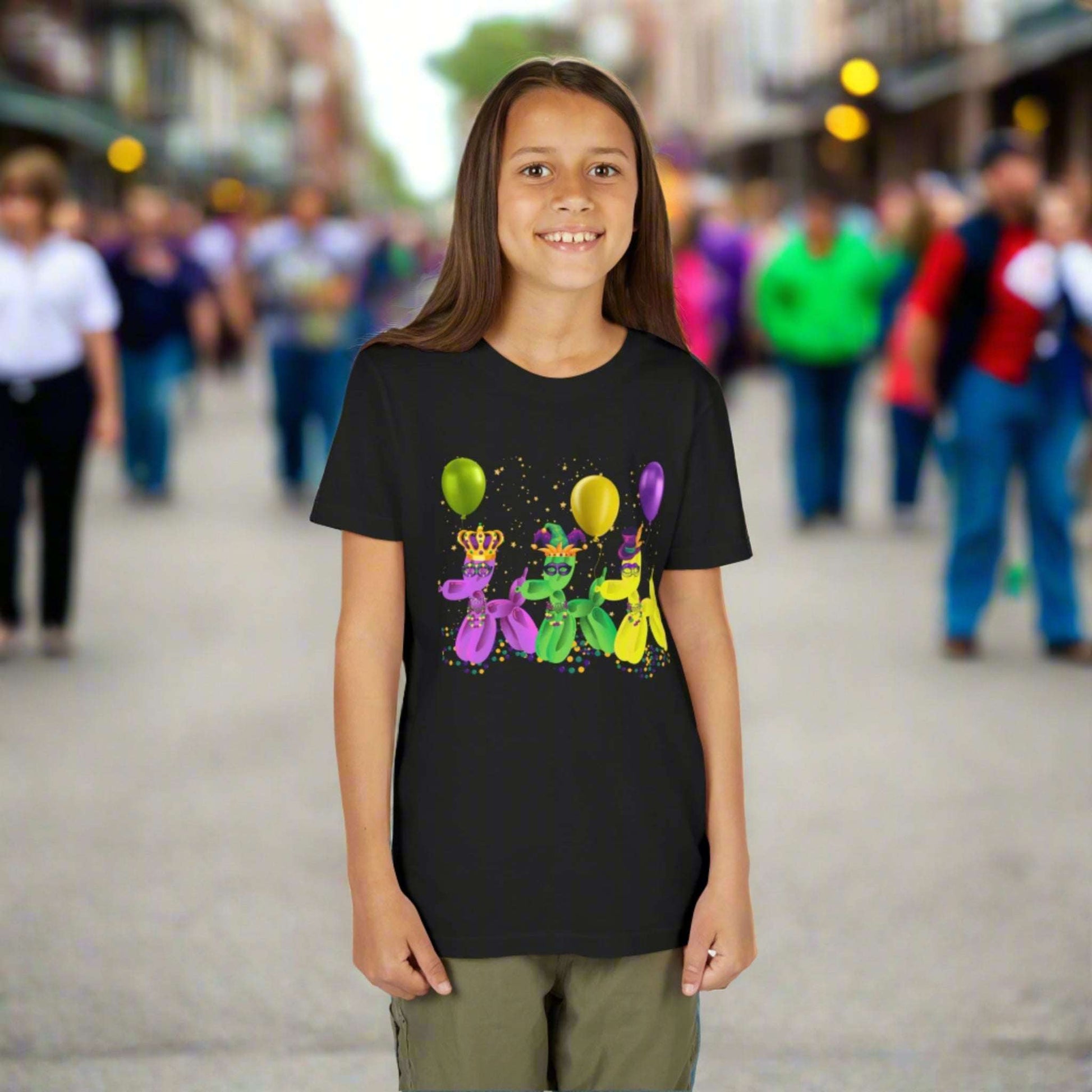 Step into Mardi Gras magic with this black youth t-shirt featuring colorful balloon dogs wearing Carnival masks. Designed for festive family matching outfits, this tee brings the joy of New Orleans parades and French Quarter energy to life. Whether they're tossing beads or just dancing on the curb, kids will love the fun “walk it like a dog” vibe on this parade-perfect Carnival shirt.