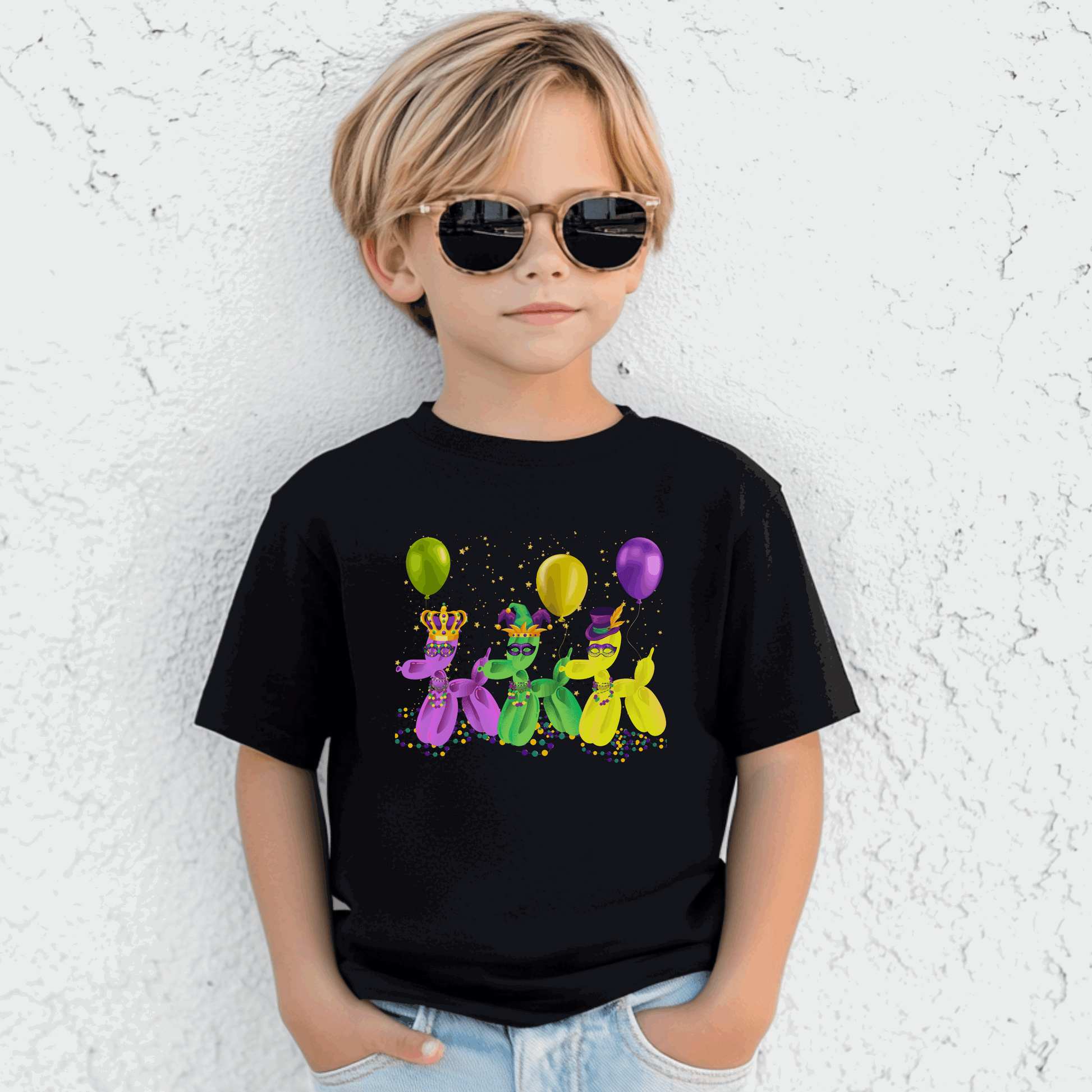 Youth black Mardi Gras t-shirt featuring three balloon dogs in purple, green, and gold wearing Carnival masks and hats. Perfect for parades in New Orleans or twirling through the French Quarter, this festive tee is made for family matching moments. A fun nod to "walk it like a dog" parade culture, it’s ideal for kids celebrating Mardi Gras in style with comfy, colorful, party-ready flair.
