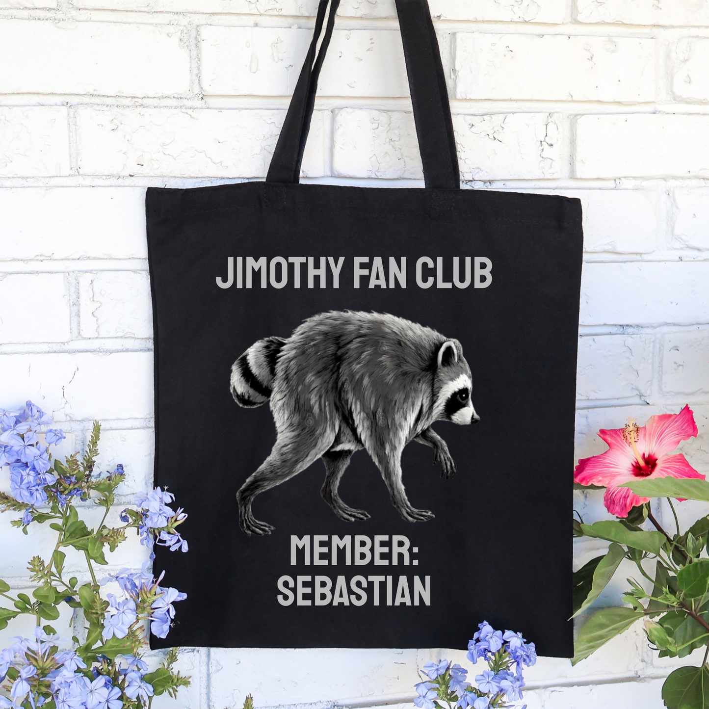 Black personalized Jimothy Fan Club tote bag featuring a quirky raccoon illustration, vintage inspired typography, and custom member name. Funny raccoon tote made from heavyweight cotton canvas for Jimothy fans, raccoon lovers, Seattle fans, and everyday use.