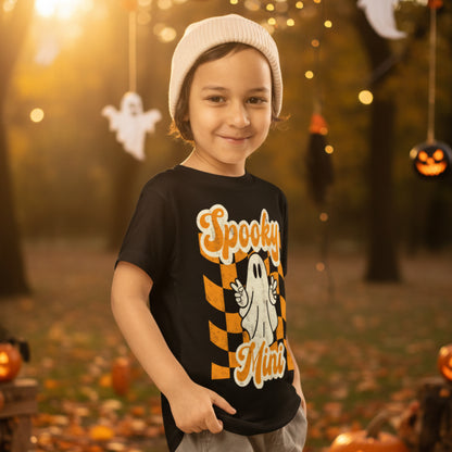 Black toddler Halloween shirt featuring a cute ghost and Spooky Mini Vibes lettering in orange and cream with a retro inspired distressed design. Perfect for toddler Halloween outfits, spooky season, family Halloween photos, pumpkin patch trips, and matching sibling outfits.