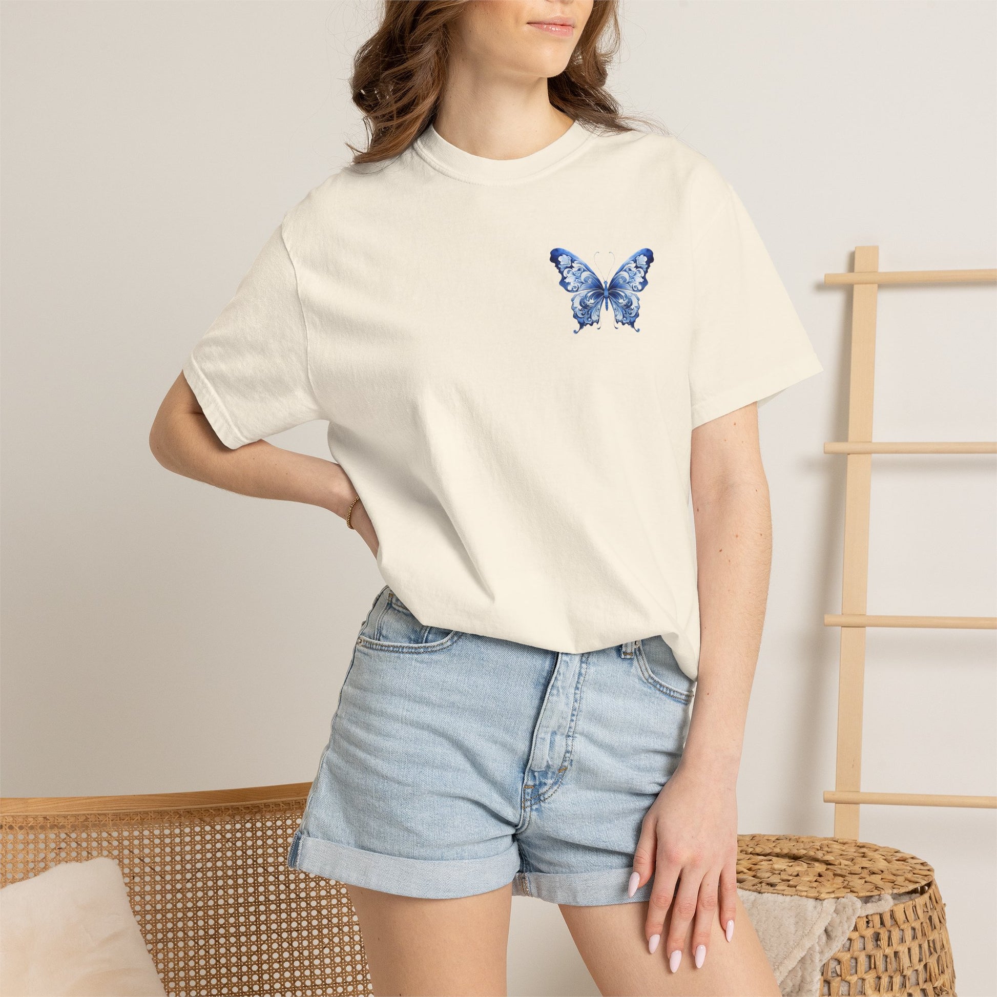 Women’s Comfort Colors 1717 t shirt with a blue toile de jouy butterfly printed on the left chest. Relaxed fit heavyweight cotton tee offered in five colors and sizes S through 4XL. Inspired by French aesthetic style, chinoiserie decor trends, and vintage botanical fashion. Cute everyday shirt for jeans, leggings, beach trips, coffee runs, weekend outfits, soft luxury wardrobes, and thoughtful gifts for butterfly lovers and stylish women.