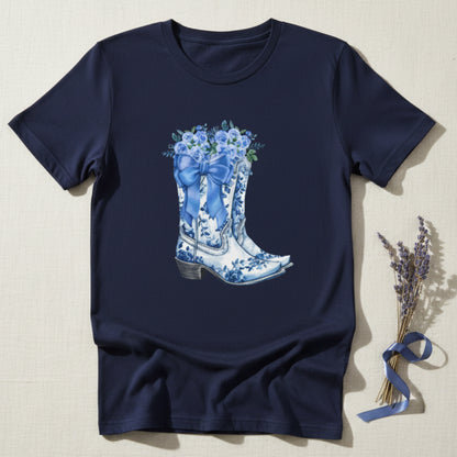 Image: Designed for girls in sizes S to XL, this country chic shirt features a whimsical scene of cowgirl boots, a blue ribbon, and floral accents. A coastal cowgirl favorite, this pullover adds just the right touch of southern sweetness to any outfit. Ideal for daughters who love soft blues, western vibes, and cozy statement pieces they can wear anywhere, by jaecrece.