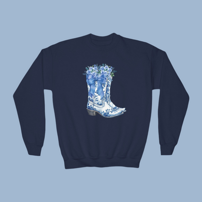 Image: Blue Toile Boots and Bows Sweatshirt in sizes for girls and toddlers. This pullover sweater features a pair of coastal cowgirl aesthetic cowboy boots with a blue bow and blue wildflowers. This country themed sweater makes a perfect gift for your daughter,  by jaecrece