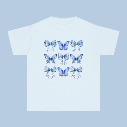 Image: Classic girls’ Comfort Colors T-shirt with a dreamy Blue Toile Butterflies & Bows print, perfect for teens and tweens who love vintage charm, butterfly fashion, or trending coquette aesthetic. Sizes XS–XL available in Chambray, White, True Navy, and Pepper. A soft girl staple and perfect for southern events or casual wear. Coordinates with women’s and toddler leggings or tees for mommy and me outfits, by jaecrece.