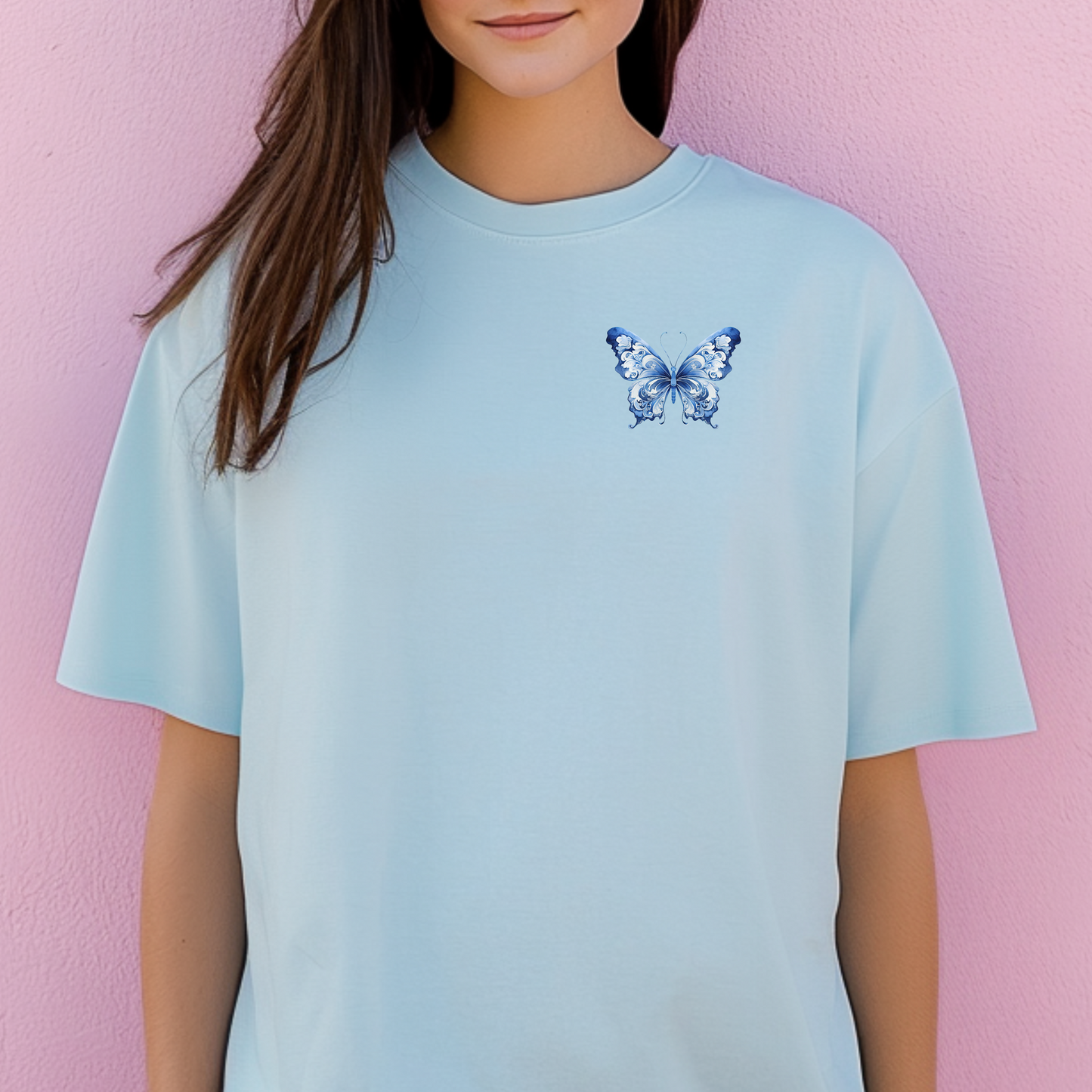 Blue Toile Butterfly Comfort Colors T-shirt for women, crafted from ultra-soft cotton with a light blue butterfly design on the upper left chest. Inspired by toile de jouy and French aesthetics, this shirt is a subtle statement piece for coastal cowgirl outfits, casual days, or garden brunches. Soft girl style meets timeless comfort in this boutique-style tee for nature lovers and butterfly fans.