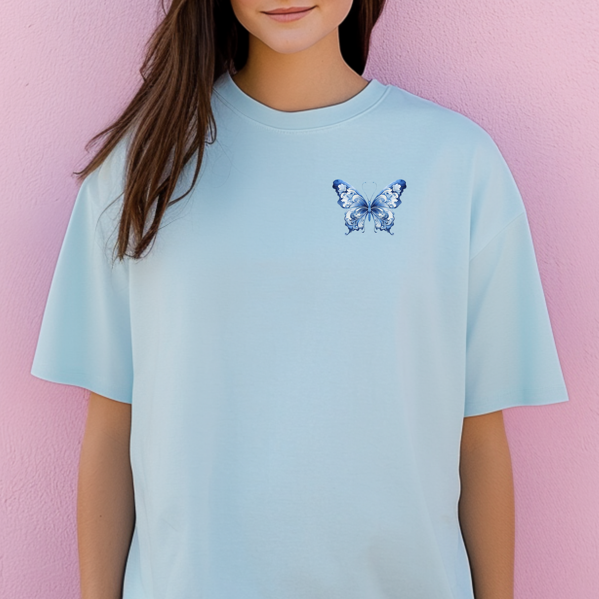 Blue Toile Butterfly Comfort Colors T-shirt for women, crafted from ultra-soft cotton with a light blue butterfly design on the upper left chest. Inspired by toile de jouy and French aesthetics, this shirt is a subtle statement piece for coastal cowgirl outfits, casual days, or garden brunches. Soft girl style meets timeless comfort in this boutique-style tee for nature lovers and butterfly fans.