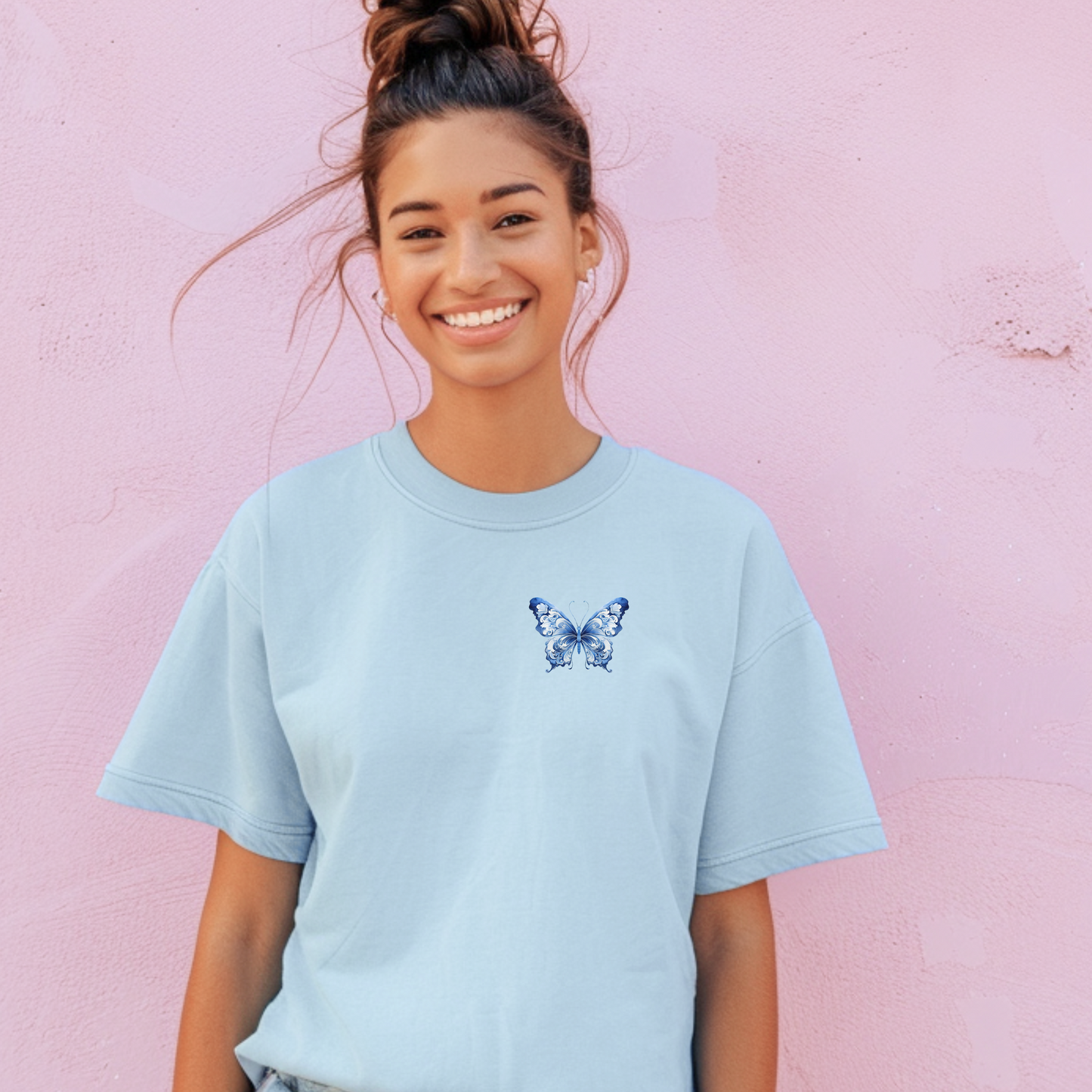 Women's Comfort Colors T-shirt in neutral tones with a blue toile butterfly printed on the left chest. Made from garment-dyed cotton for a vintage look and ultra-soft feel. A stylish addition to any wardrobe that loves the soft girl aesthetic, coastal cowgirl trend, or cottagecore fashion. Ideal for brunch, errands, or casual chic outfits with a whimsical, feminine touch.