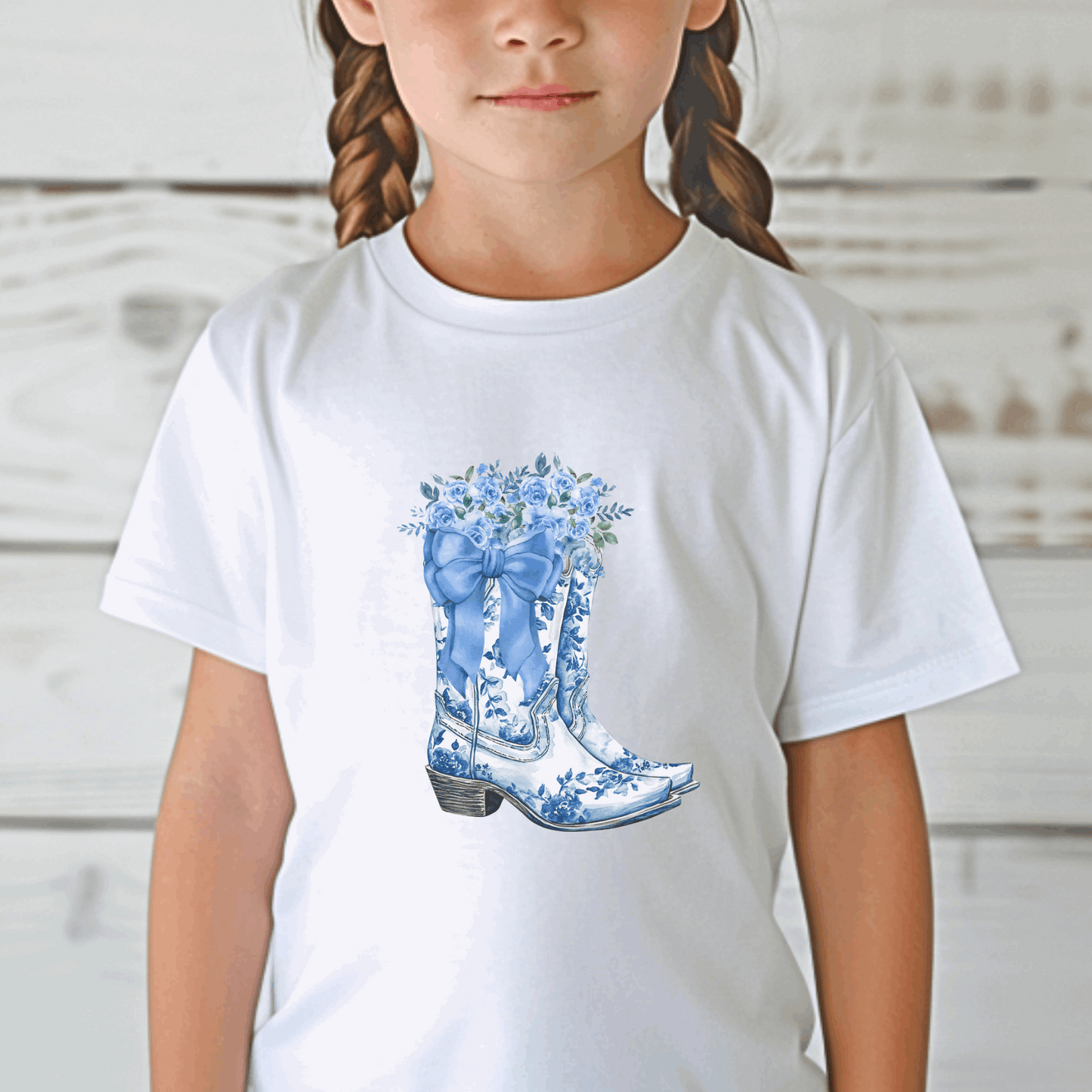 The Blue Toile Floral Cowboy Boots Toddler Tee brings together soft girl vibes and Texas cowgirl charm in one adorable piece. Featuring a classic blue toile print and dainty cowboy boots, this western toddler shirt is great for country birthdays, rodeo days, or dressing up your mini-me for the fair. It’s the perfect blend of toile de jouy, French cottagecore, and toddler western wear—ideal for trend-loving moms and stylish kids.