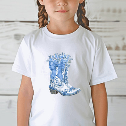 The Blue Toile Floral Cowboy Boots Toddler Tee brings together soft girl vibes and Texas cowgirl charm in one adorable piece. Featuring a classic blue toile print and dainty cowboy boots, this western toddler shirt is great for country birthdays, rodeo days, or dressing up your mini-me for the fair. It’s the perfect blend of toile de jouy, French cottagecore, and toddler western wear—ideal for trend-loving moms and stylish kids.