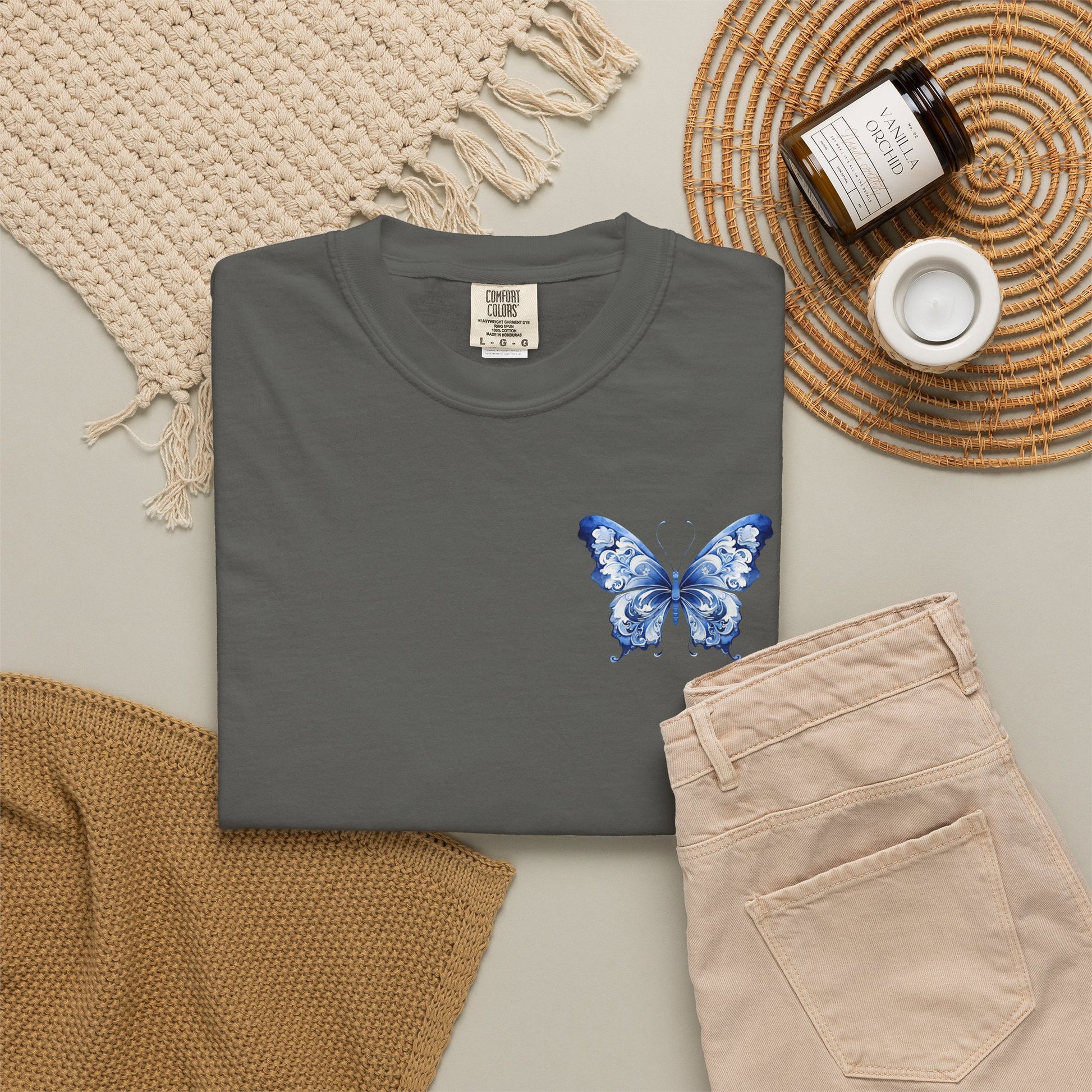Garment dyed Comfort Colors 1717 shirt featuring a blue butterfly in classic toile de jouy style placed on the left chest. Available in five colors and sizes S through 4XL. This relaxed women’s tee captures old money casual fashion with coastal elegance and French countryside charm. Great for pairing with denim shorts, yoga pants, lounge wear, sneakers, or layered cardigans for an effortless boutique style outfit.