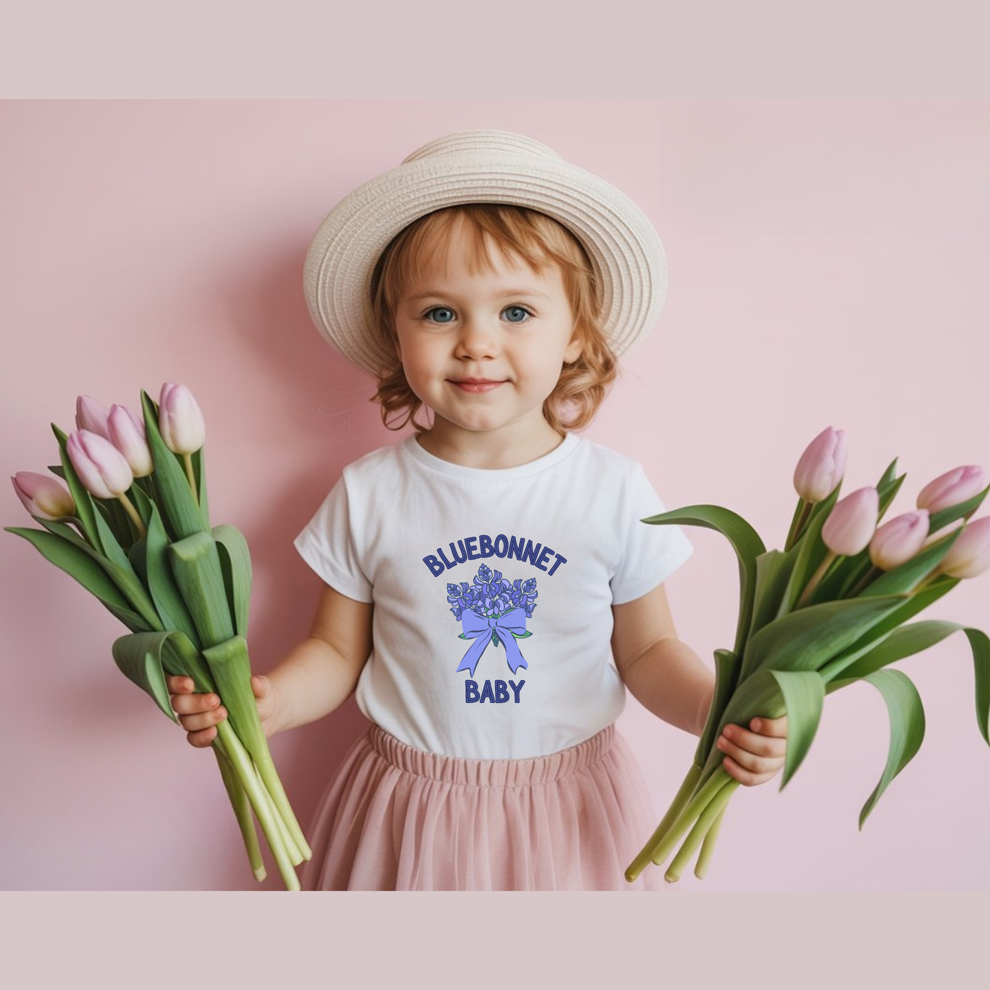 Close up of the bluebonnet design on a white Texas baby T shirt, showing the detailed Texas wildflower graphic printed on a soft BELLA CANVAS 3001B infant tee, a sweet choice for a Texas baby gift or baby shower gift