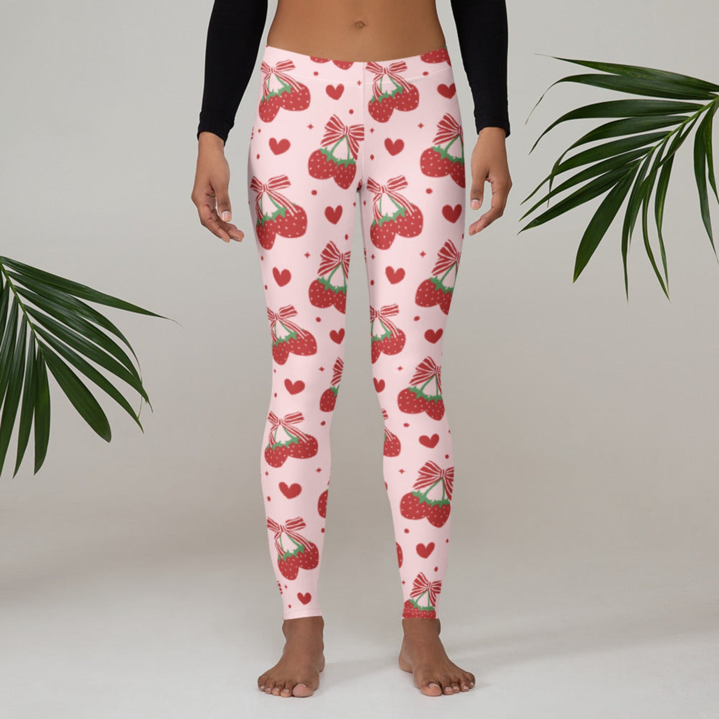 Image: These coquette inspired leggings are made for women who love playful prints and soft, stretchy comfort. Decorated with red bows and strawberry accents on a pink base, they’re perfect in sizes XS through XL. Whether paired with ballet flats, hoodies, or tank tops, these leggings offer endless outfit options for those who adore girly details with a modern twist, by jaecrece.