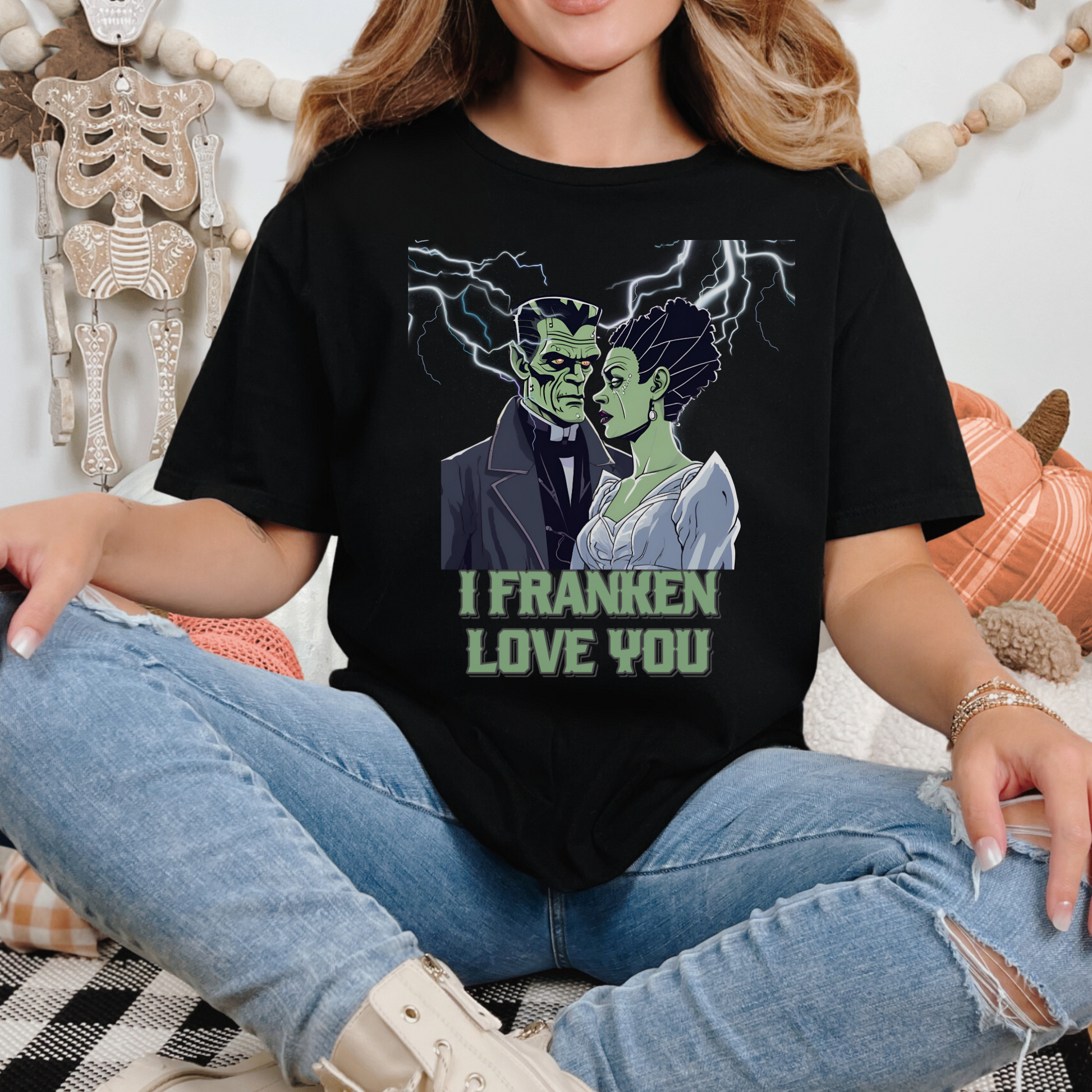 Cute and spooky Halloween graphic shirt with romantic Frankenstein and bride, lightning background, “I Franken Love You.” Soft black unisex Gildan 64000 tee, S-5XL, perfect for Halloween humor, date night, or unique Halloween gifts for her or him.