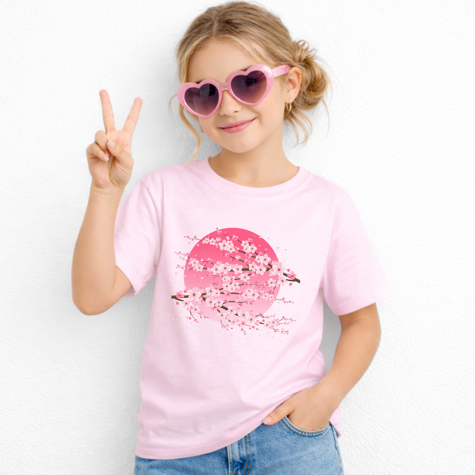 Pink cherry blossom graphic t shirt for girls featuring sakura flowers and a dramatic pink moon inspired backdrop. This Japanese aesthetic children's tee offers a fun floral look that pairs easily with casual everyday clothing.