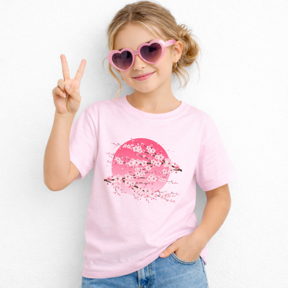 Pink cherry blossom graphic t shirt for girls featuring sakura flowers and a dramatic pink moon inspired backdrop. This Japanese aesthetic children's tee offers a fun floral look that pairs easily with casual everyday clothing.