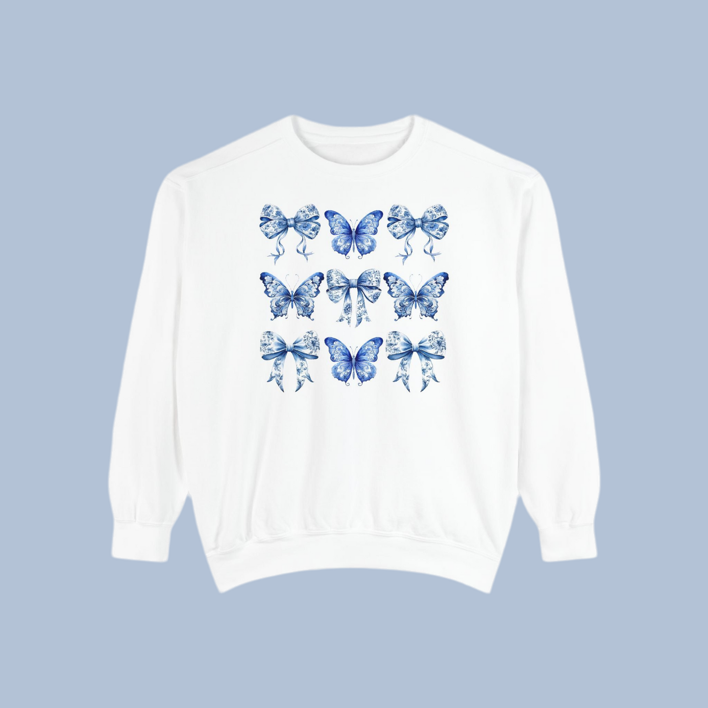 Image: Feminine women’s sweatshirt in charming blue toile design with whimsical butterflies and bows, great for cottagecore and spring fashion lovers. This piece fits into the Texas coquette trend with its graceful design and easy wearability. Match with toddler and youth pieces in our shop for a coordinated family outfit for holidays or birthdays, by jaecrece.