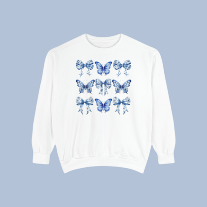 Image: Feminine women’s sweatshirt in charming blue toile design with whimsical butterflies and bows, great for cottagecore and spring fashion lovers. This piece fits into the Texas coquette trend with its graceful design and easy wearability. Match with toddler and youth pieces in our shop for a coordinated family outfit for holidays or birthdays, by jaecrece.