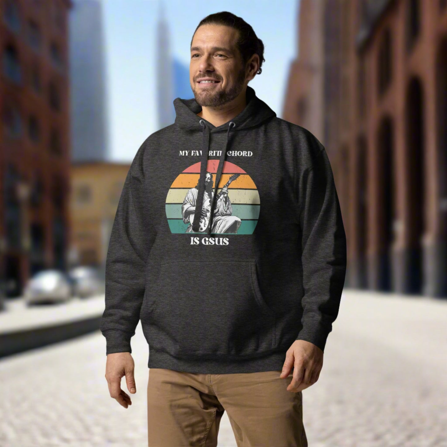 Lifestyle shot of a musician wearing the “My Favorite Chord Is GSUS” hoodie during rehearsal. This cozy, unisex hoodie blends faith and humor with a music pun that resonates with worship teams, choir directors, and Christian guitarists. Soft cotton-blend fleece and a roomy front pouch pocket make it ideal for chilly practice sessions.