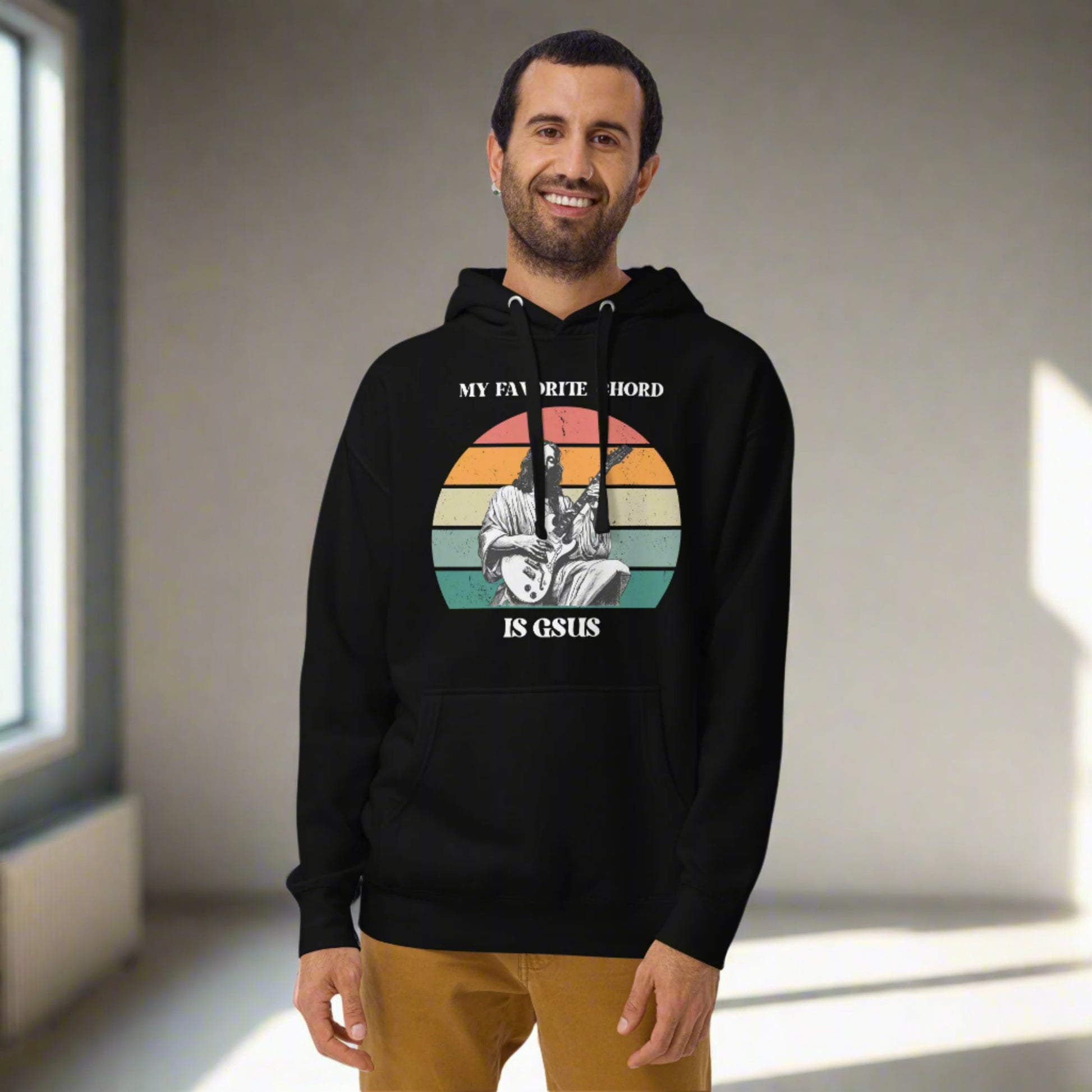 Person wearing a “My Favorite Chord Is GSUS” hoodie. This cozy, unisex pullover combines faith and musical humor with soft cotton blend fleece fabric. Designed for all sizes from S to 3XL, it’s a great gift for Christian musicians, guitarists, worship leaders, and choir members.

