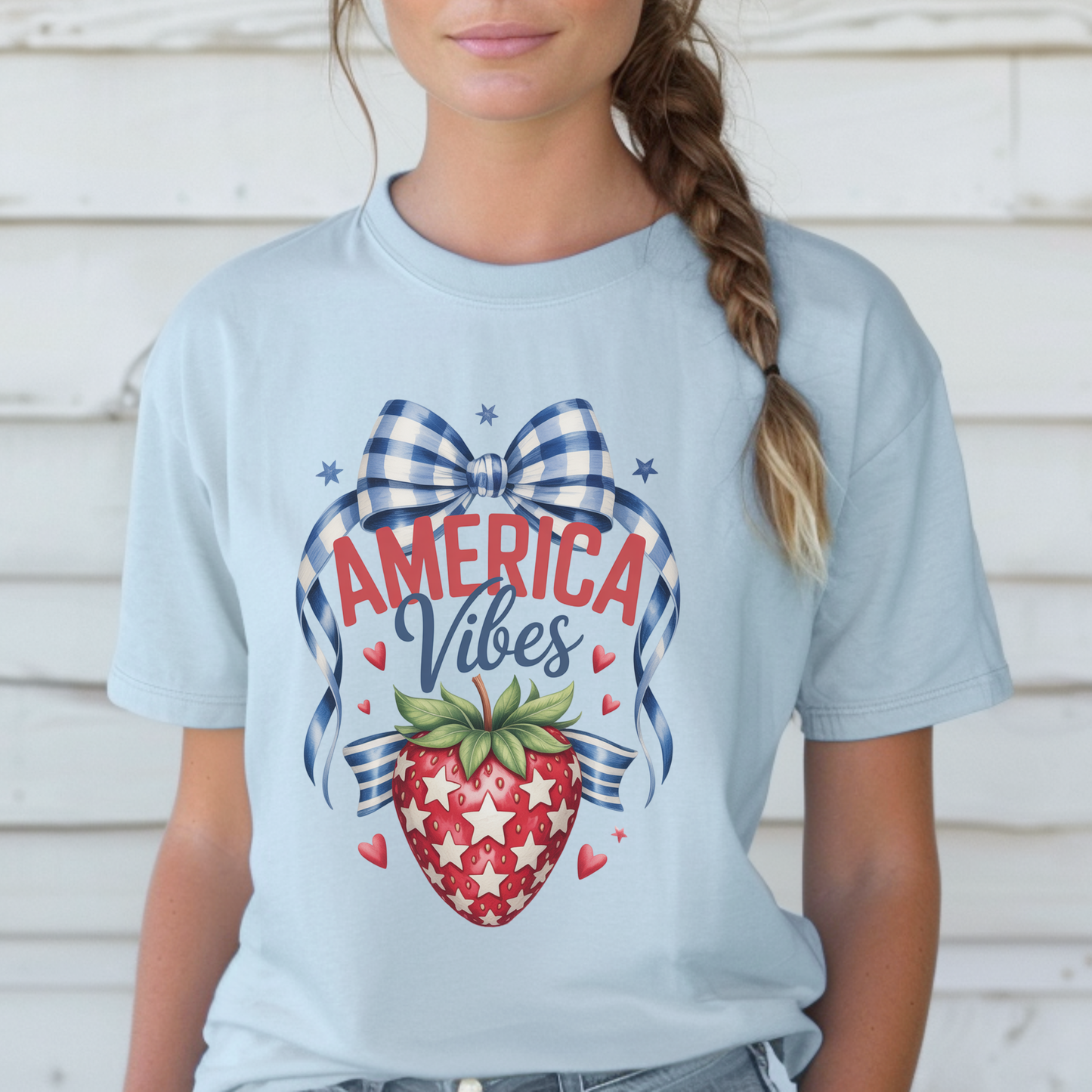 Comfort Colors patriotic strawberry t shirt in chambray featuring hand drawn strawberry artwork with gingham bow details stars and heart accents inspired by America 250 and the 250th anniversary of the United States. Soft garment dyed cotton tee with relaxed fit perfect for 4th of July outfits mommy and me matching looks Memorial Day family gatherings backyard barbecues and vintage Americana summer fashion