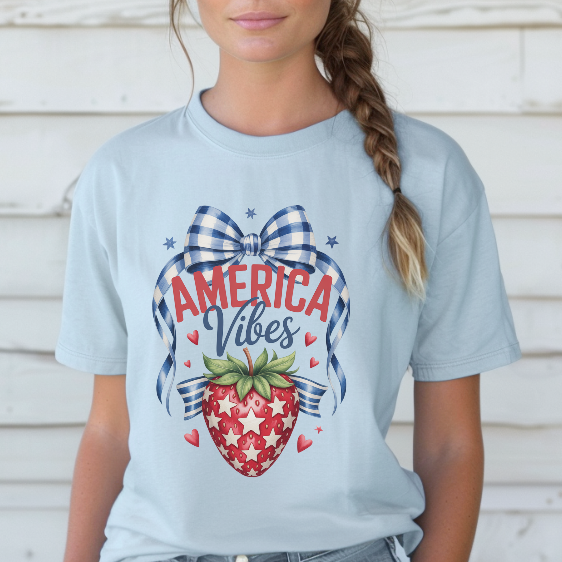 Comfort Colors patriotic strawberry t shirt in chambray featuring hand drawn strawberry artwork with gingham bow details stars and heart accents inspired by America 250 and the 250th anniversary of the United States. Soft garment dyed cotton tee with relaxed fit perfect for 4th of July outfits mommy and me matching looks Memorial Day family gatherings backyard barbecues and vintage Americana summer fashion
