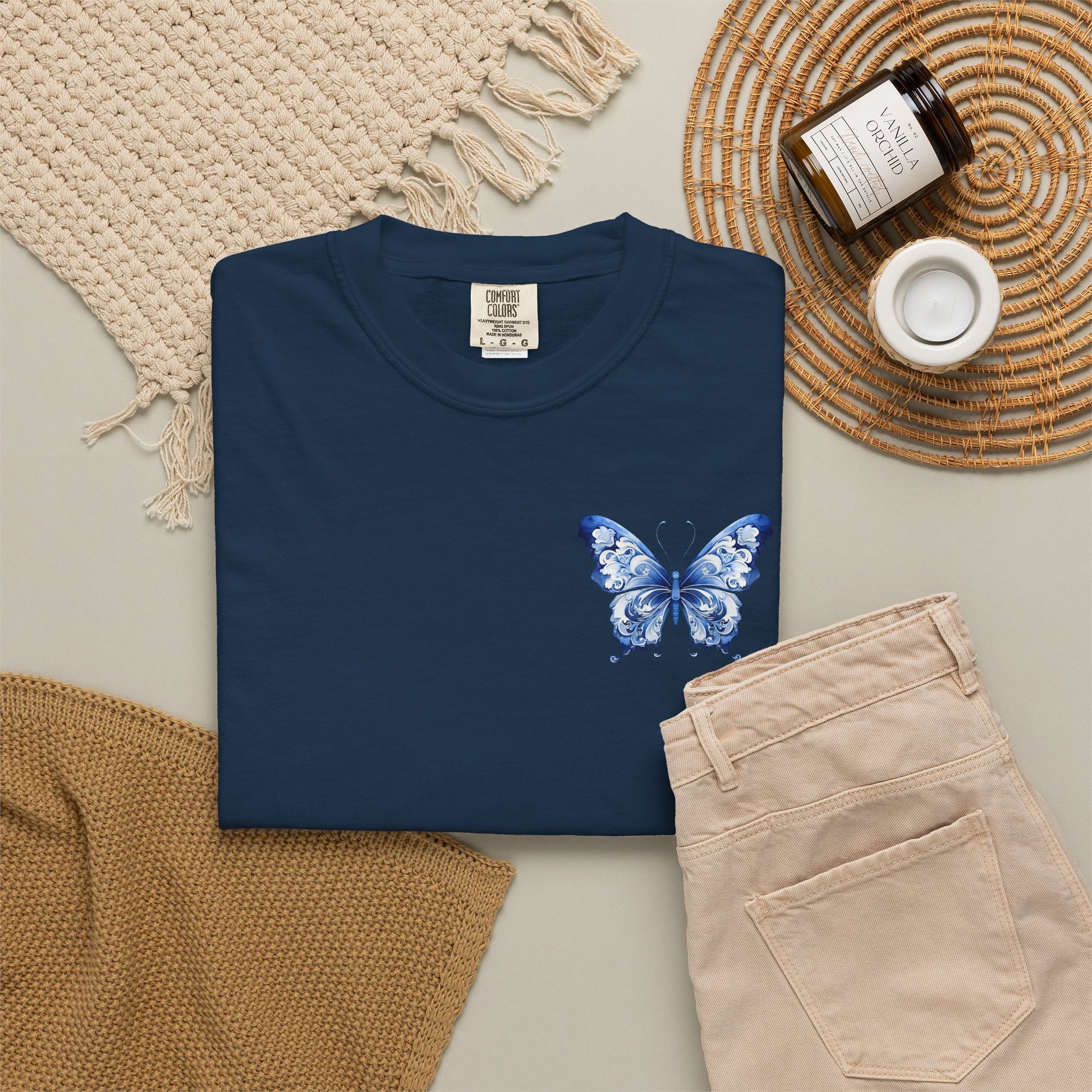 Comfort Colors butterfly shirt for women featuring a blue toile print butterfly on the left chest for a subtle elegant look. Available in five colors and sizes S through 4XL. Relaxed fit cotton tee inspired by French vintage decor, chinoiserie art, and timeless boutique fashion. Perfect for pairing with jeans, workout pants, skirts, sandals, or layered fall outfits. Great gift for moms, daughters, and butterfly lovers.