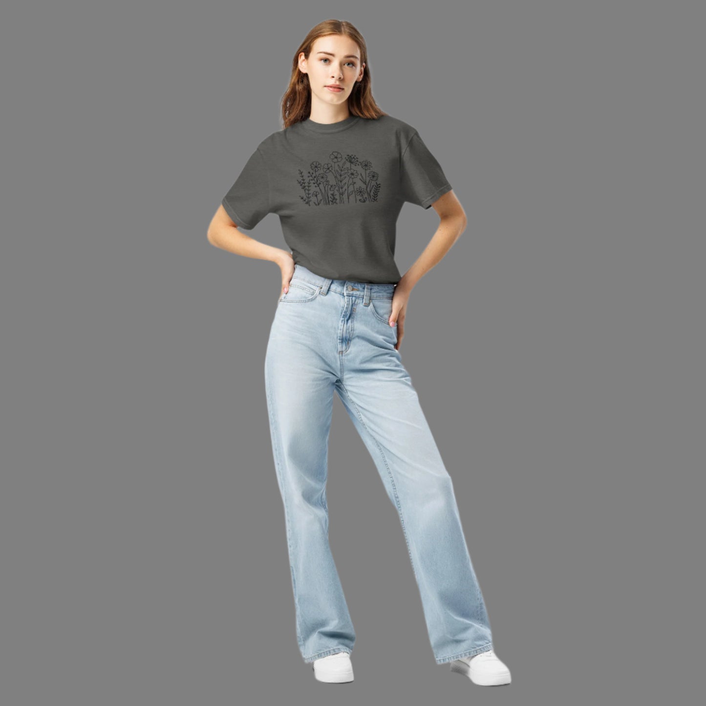 Image: A stylish dark grey crewneck shirt featuring black wildflower embroidery, blending a boho-chic aesthetic with classic casualwear. The floral pattern is stitched with precision, creating a subtle yet intricate nature-inspired motif. Whether paired with jeans or leggings, this embroidered sweater adds effortless charm to any wardrobe, making it an excellent gift for flower lovers and nature enthusiasts alike, by jaecrece.