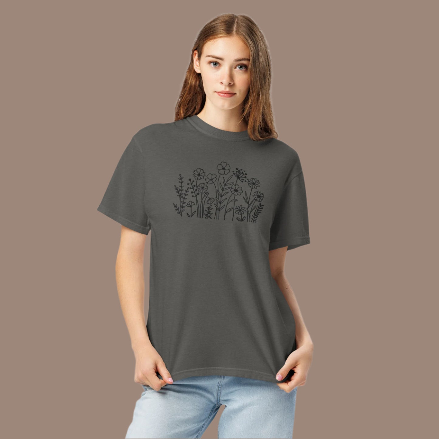 Image: A stylish dark grey crewneck shirt featuring black wildflower embroidery, blending a boho-chic aesthetic with classic casualwear. The floral pattern is stitched with precision, creating a subtle yet intricate nature-inspired motif. Whether paired with jeans or leggings, this embroidered sweater adds effortless charm to any wardrobe, making it an excellent gift for flower lovers and nature enthusiasts alike, by jaecrece.