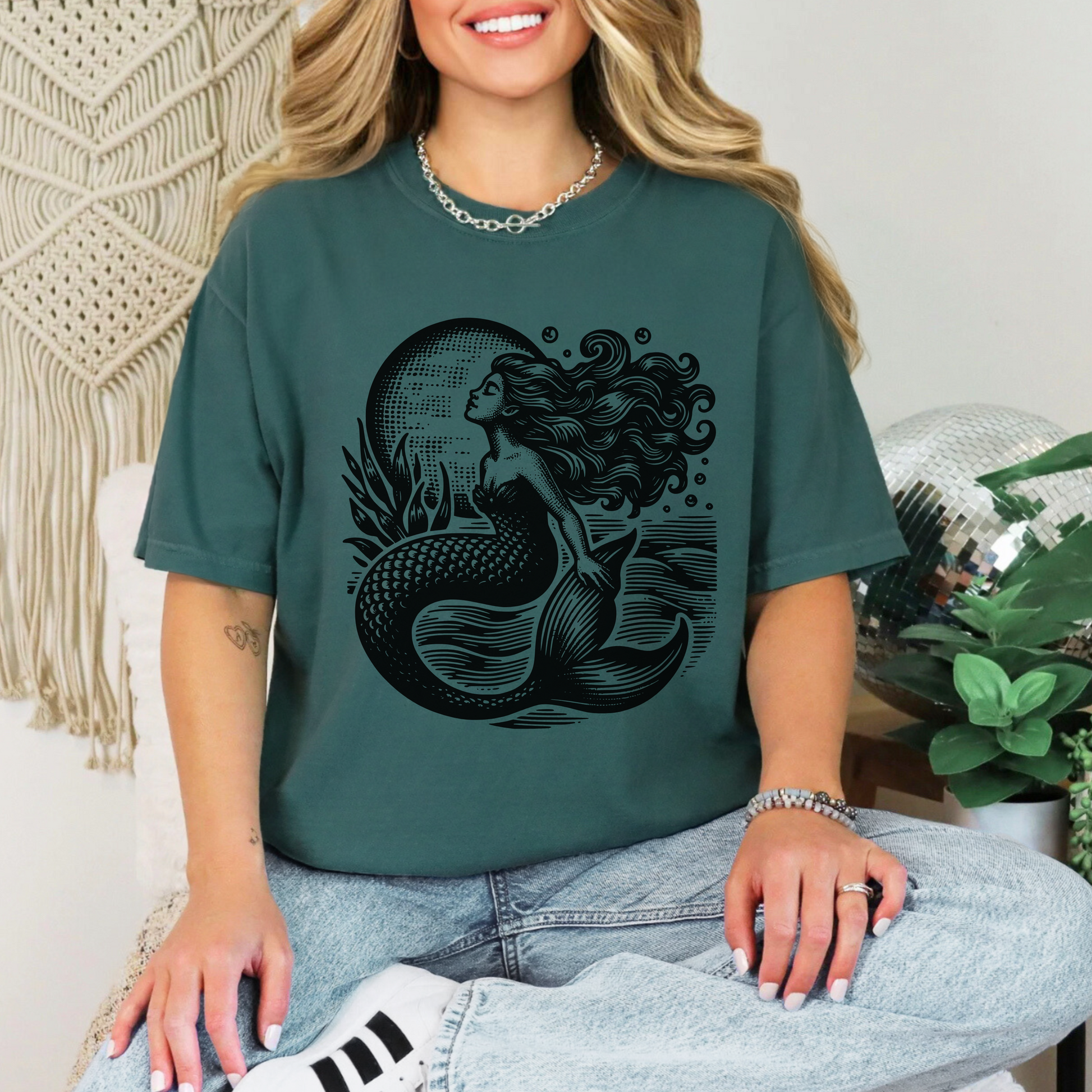 Image: Soft-washed Comfort Colors tee with a faded blue vintage mermaid illustration, inspired by nautical folklore and fisherman aesthetic. Ideal for ocean lovers, cottagecore girls, and anyone embracing the mermaidcore or coastal cowgirl trends. Whether exploring seaside towns or packing for summer festivals, this retro tee brings dreamy maritime style to any warm-weather wardrobe, by jaecrece.