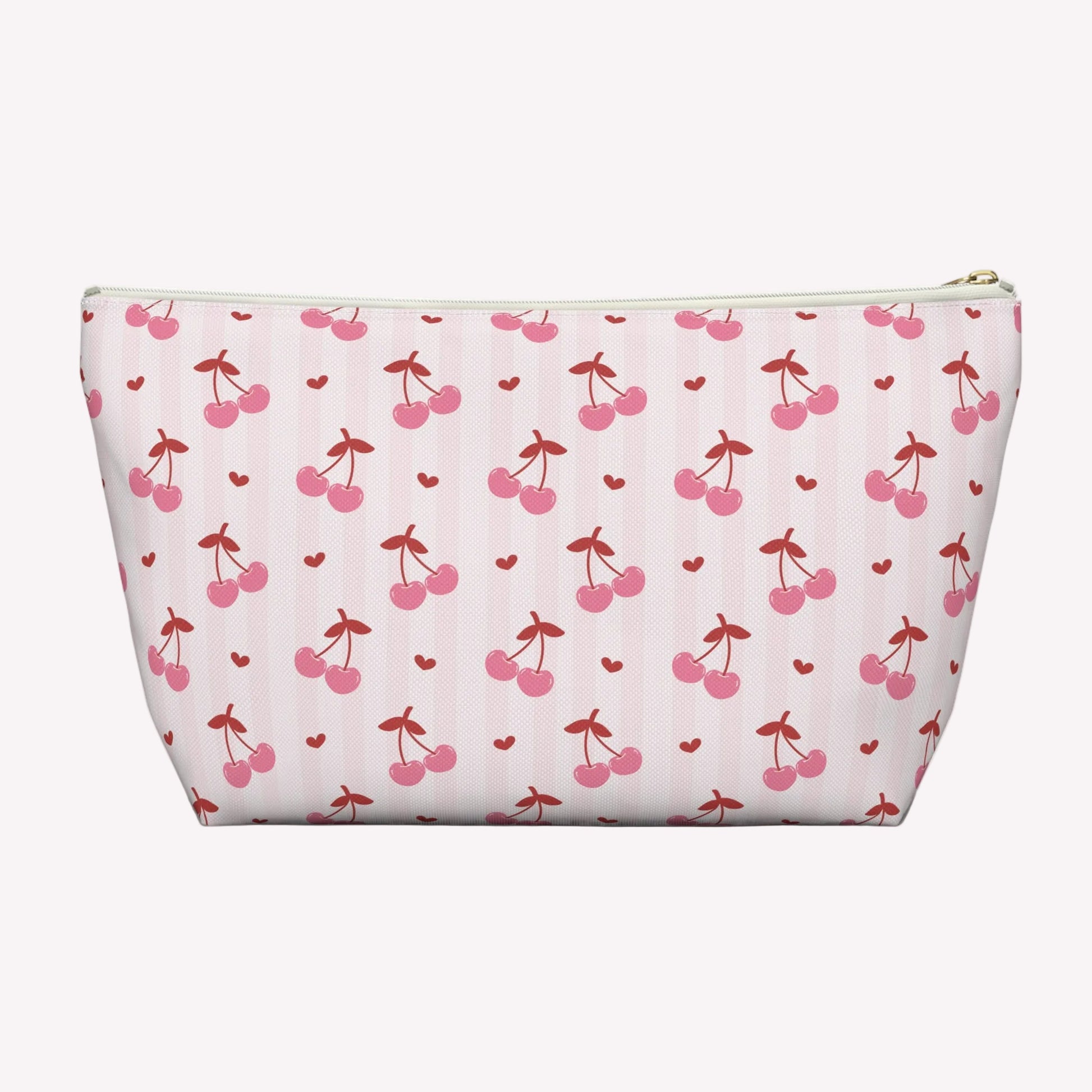 Pink cherry toiletry pouch with custom name detail and playful coquette aesthetic designed for stylish everyday organization. This personalized makeup bag features vibrant cherry illustrations, scattered hearts, durable spun polyester fabric, and a roomy interior for cosmetics, toiletries, chargers, snacks, and self care essentials. Lightweight and travel friendly cosmetic case fits easily into tote bags, backpacks, luggage, and weekender bags. Great gift for birthdays, sleepovers, vacations, and bridal par