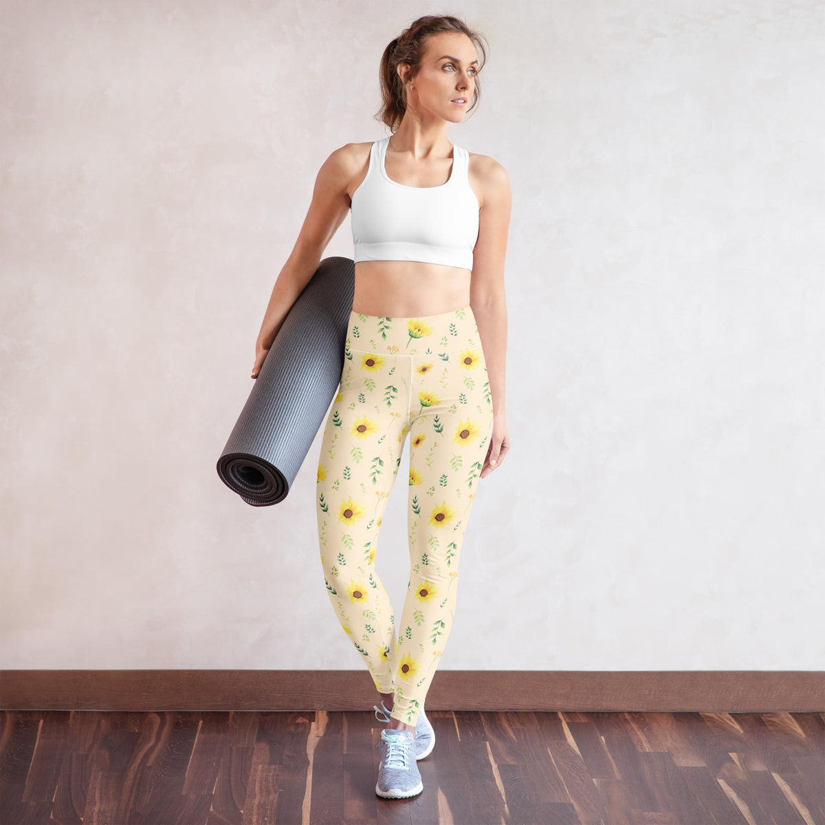 A cottagecore inspired outfit featuring women's sunflower leggings with a soft cream background, yellow flowers, and delicate green botanical details. The nature inspired print has a relaxed garden feel that works beautifully with simple casual pieces. These full length leggings can be styled for spring and summer outings, gardening, farmers markets, nature walks, travel, family activities, or an easy everyday outfit.