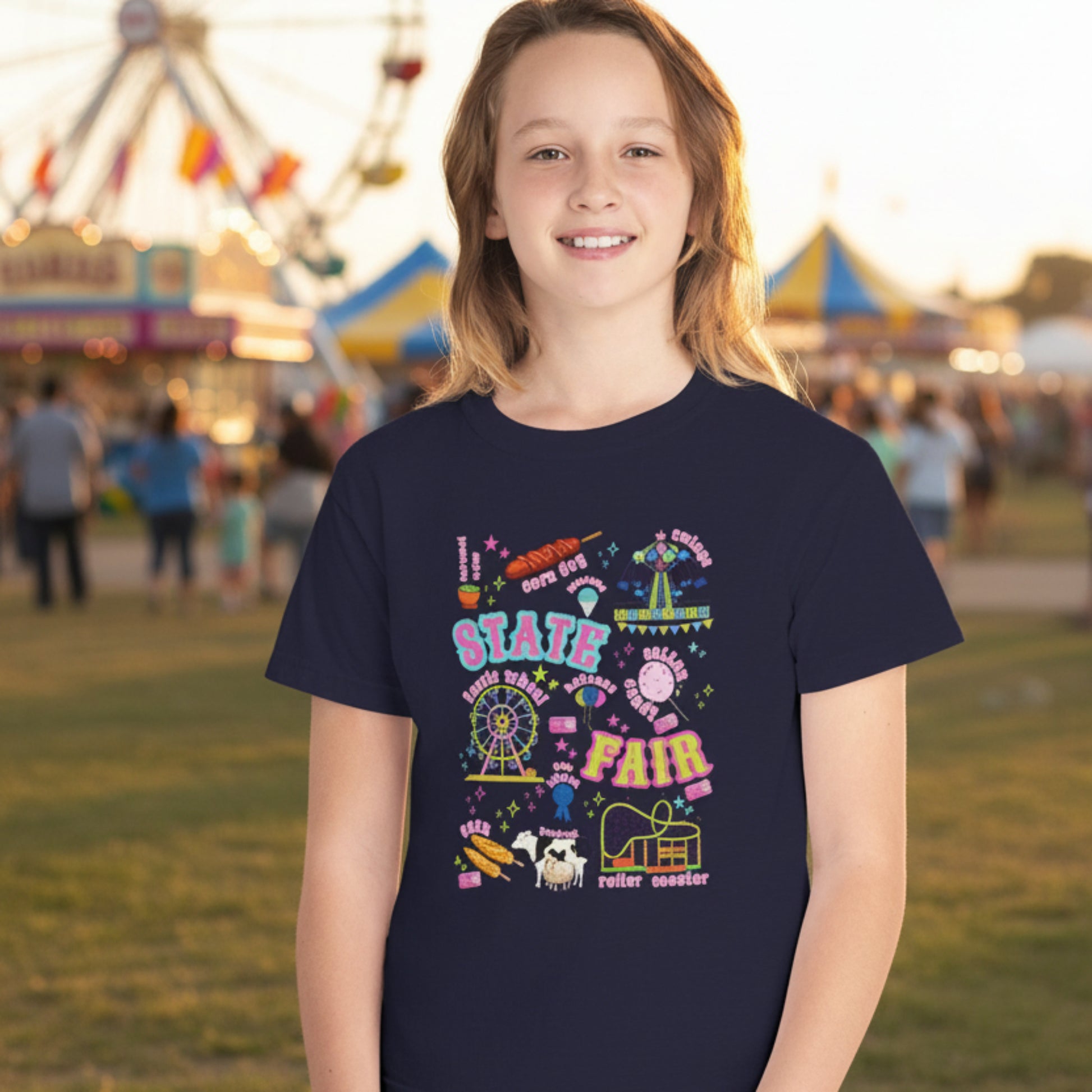 Kids county fair shirt with a colorful retro graphic featuring classic midway and agricultural fair imagery including a Ferris wheel, roller coaster, carnival ride, cotton candy, funnel cake, corn dogs, livestock, blue ribbon and tickets. A fun vintage inspired design for county fairs, livestock shows and summer festivals.