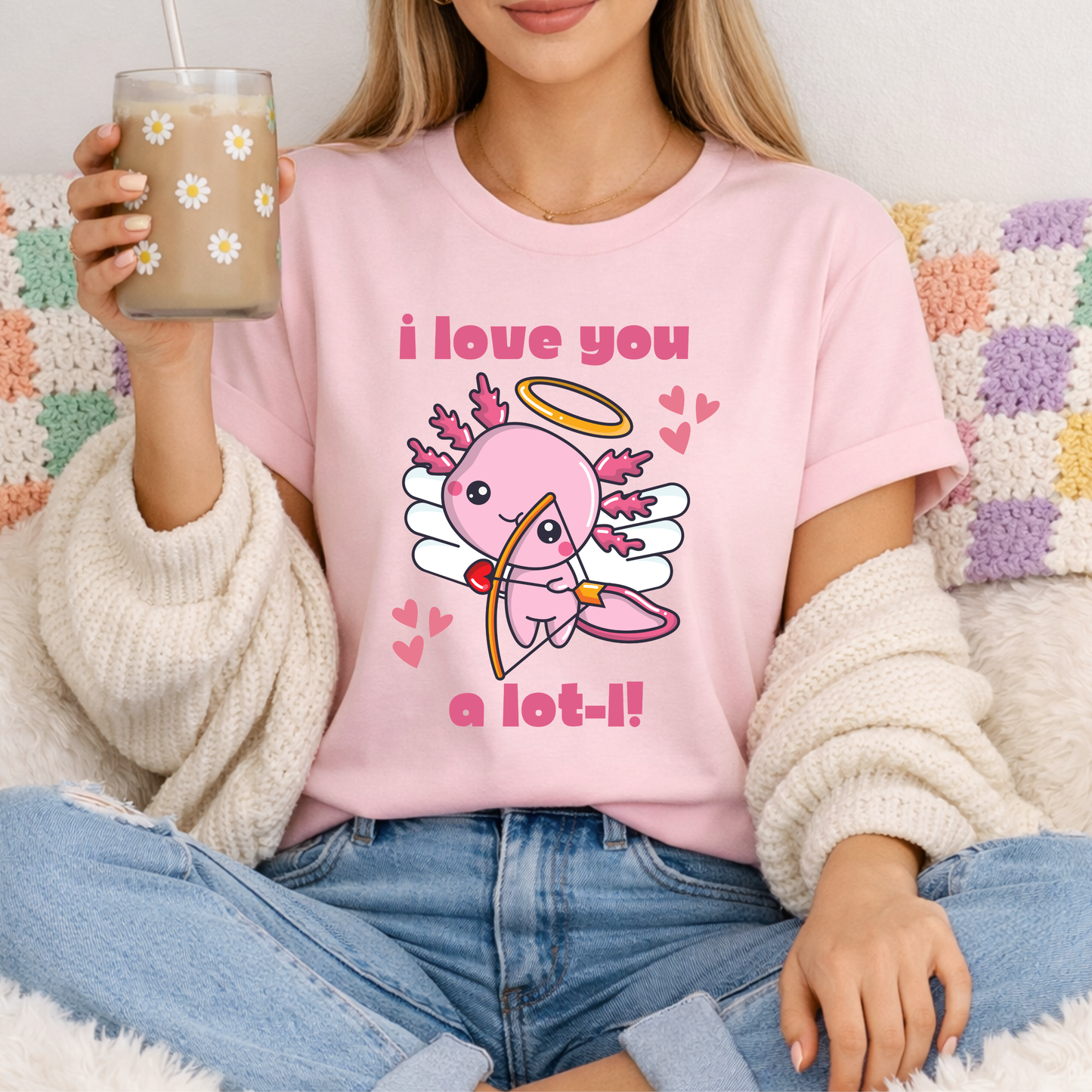Pink Bella Canvas 3001 tshirt with the I Love You A Lot L Axolotl Cupid graphic showing an adorable cupid axolotl and sweet heart details. Soft unisex tee available in adult sizes XS to 5XL with child sizes for coordinating family looks. The pink shirt color adds a fun romantic feel that is perfect for Valentine season and year round wear. Comfortable lightweight top for brunch, school events, girls outings, casual days, or gifting to anyone who loves cute animal themed fashion.