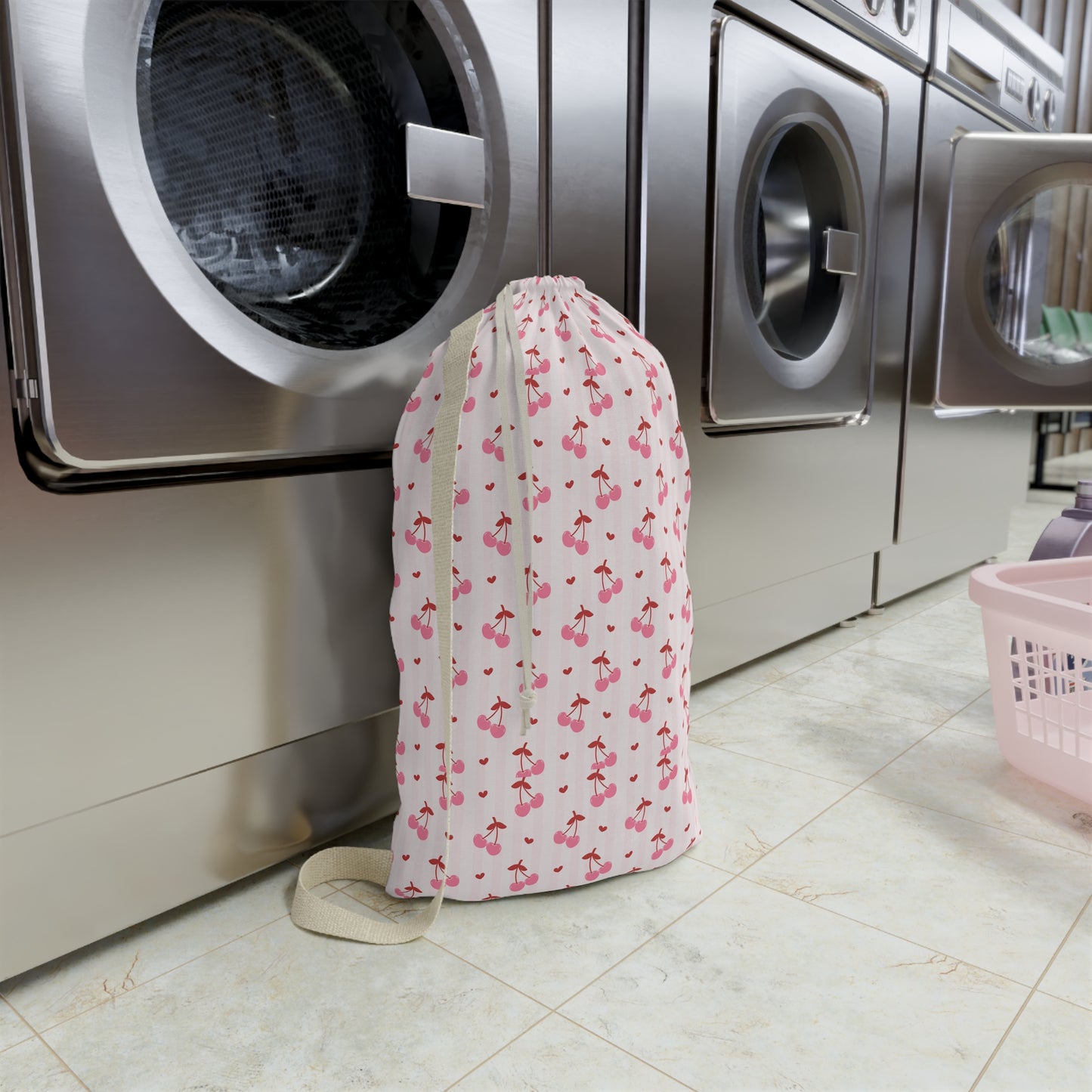 The personalized coquette cherry laundry bag shown filled with clothing to demonstrate its generous capacity. Designed for busy families, college students, campers, and travelers, this large drawstring sack easily stores a full load of laundry while keeping belongings organized. The playful cherry print and custom name personalization create a stylish accessory that coordinates with matching travel bags.